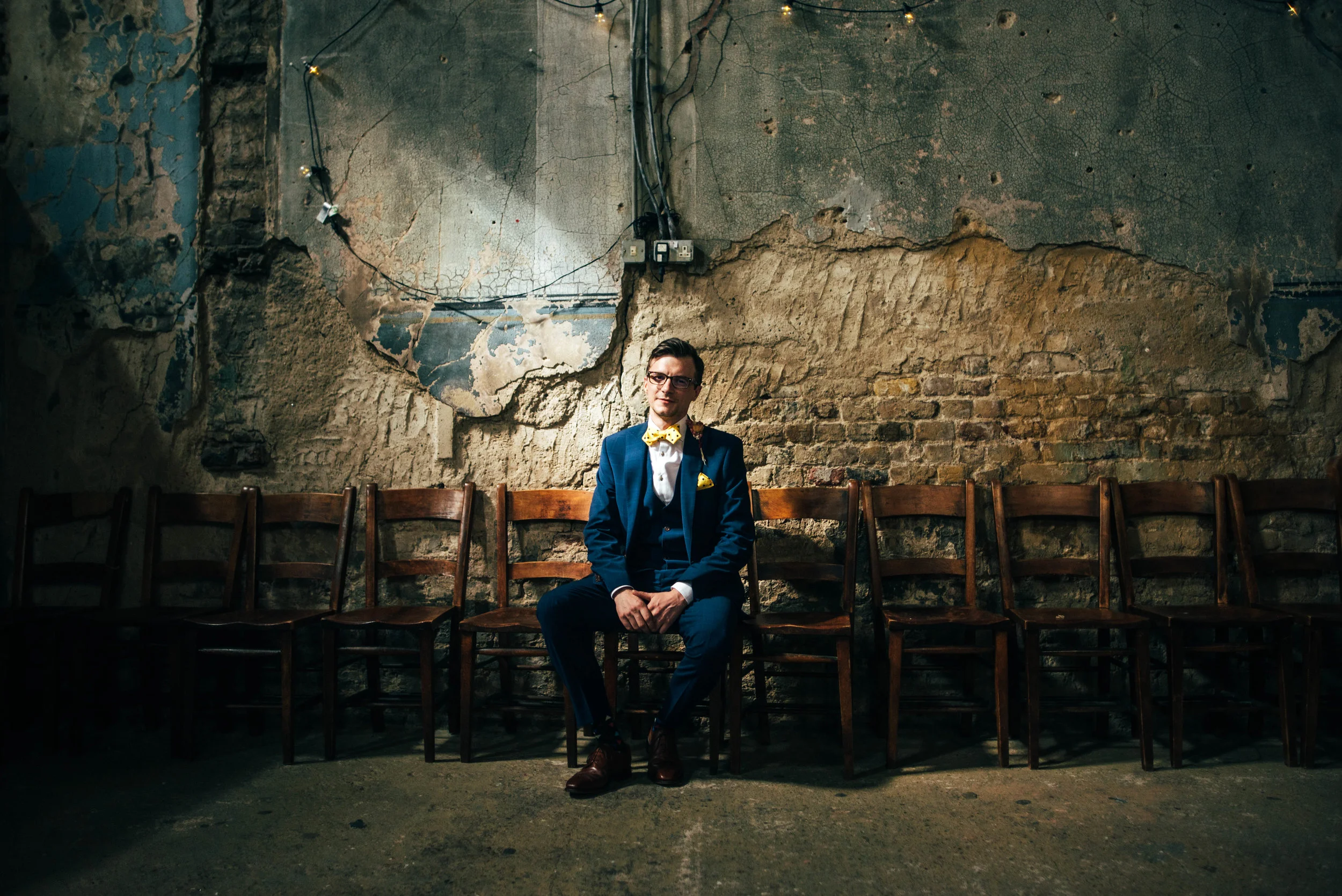Groom in beam of light at Asylum London Essex Documentary Wedding Photographer