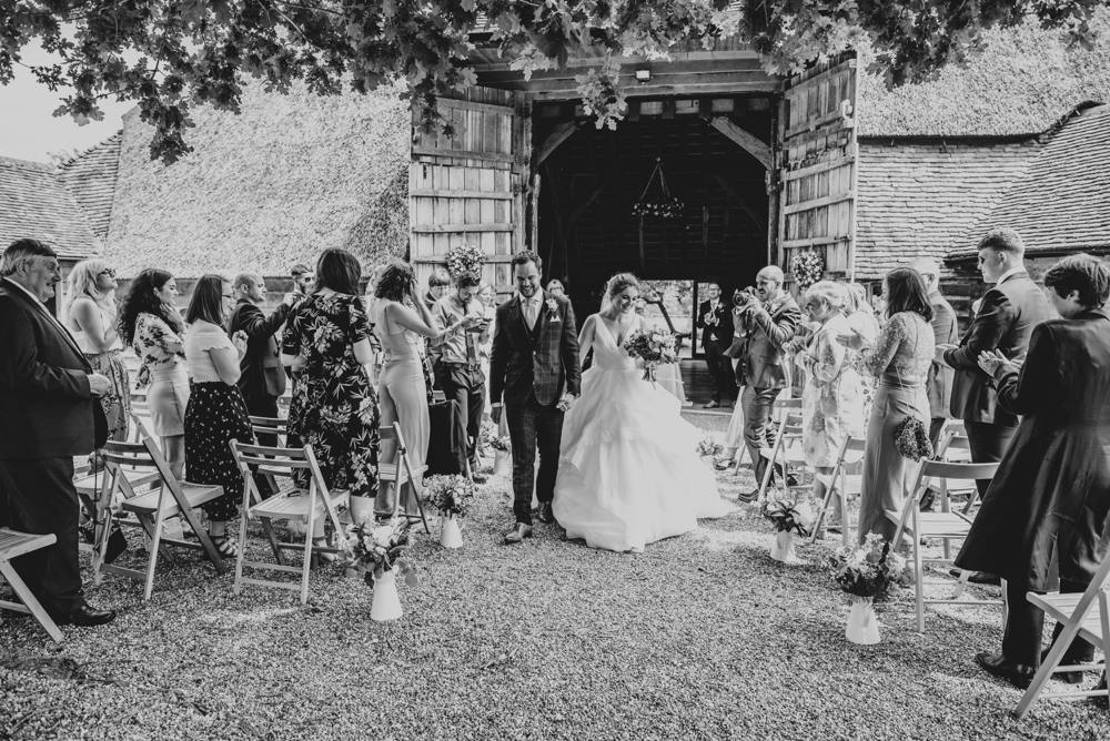 Rustic Summer wedding at Ratsbury Barn with Mini Golf, lawn games, pizza and home-made cake. Bride wears Mori Lee. Essex Documentary Wedding Photographer