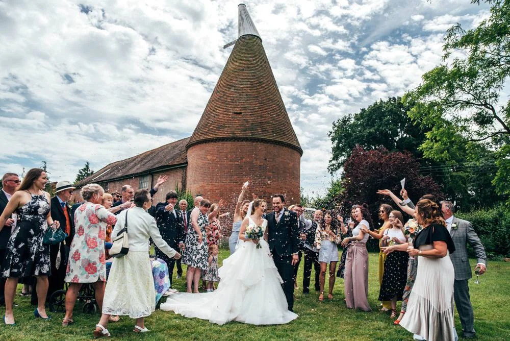 Rustic Summer wedding at Ratsbury Barn with Mini Golf, lawn games, pizza and home-made cake. Bride wears Mori Lee. Essex Documentary Wedding Photographer