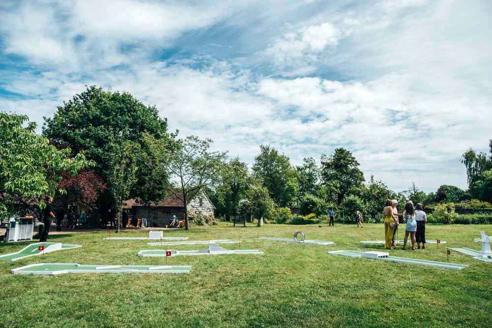 Rustic Summer wedding at Ratsbury Barn with Mini Golf, lawn games, pizza and home-made cake. Bride wears Mori Lee. Essex Documentary Wedding Photographer