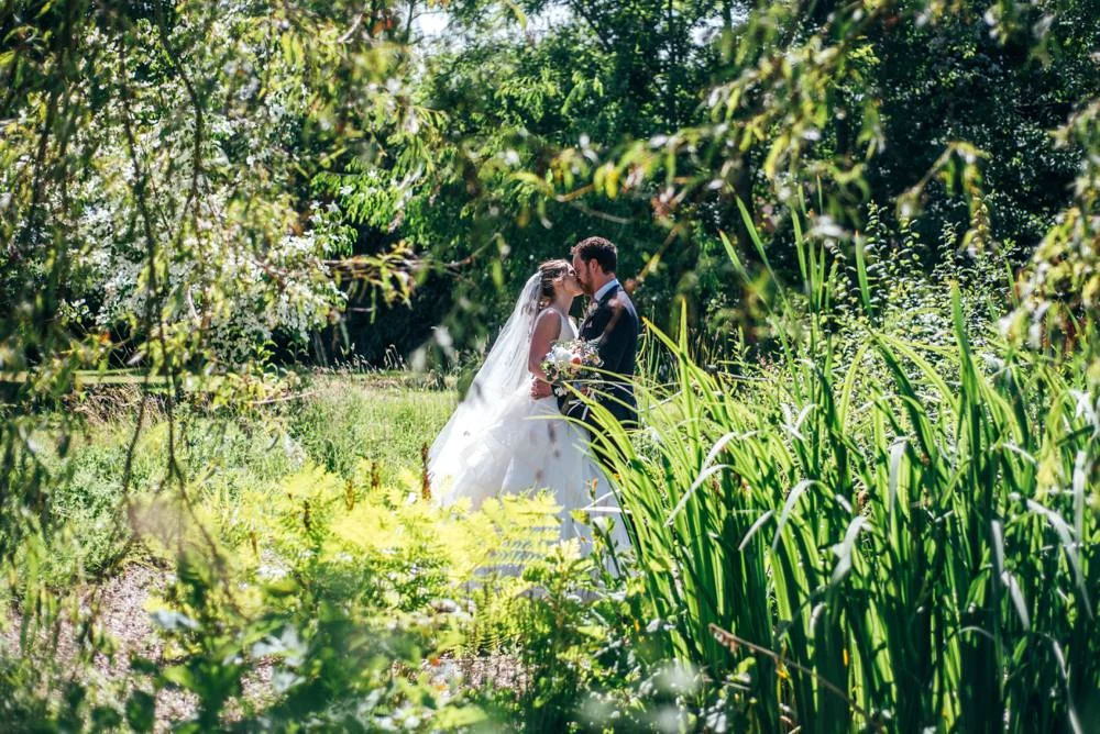 Rustic Summer wedding at Ratsbury Barn with Mini Golf, lawn games, pizza and home-made cake. Bride wears Mori Lee. Essex Documentary Wedding Photographer