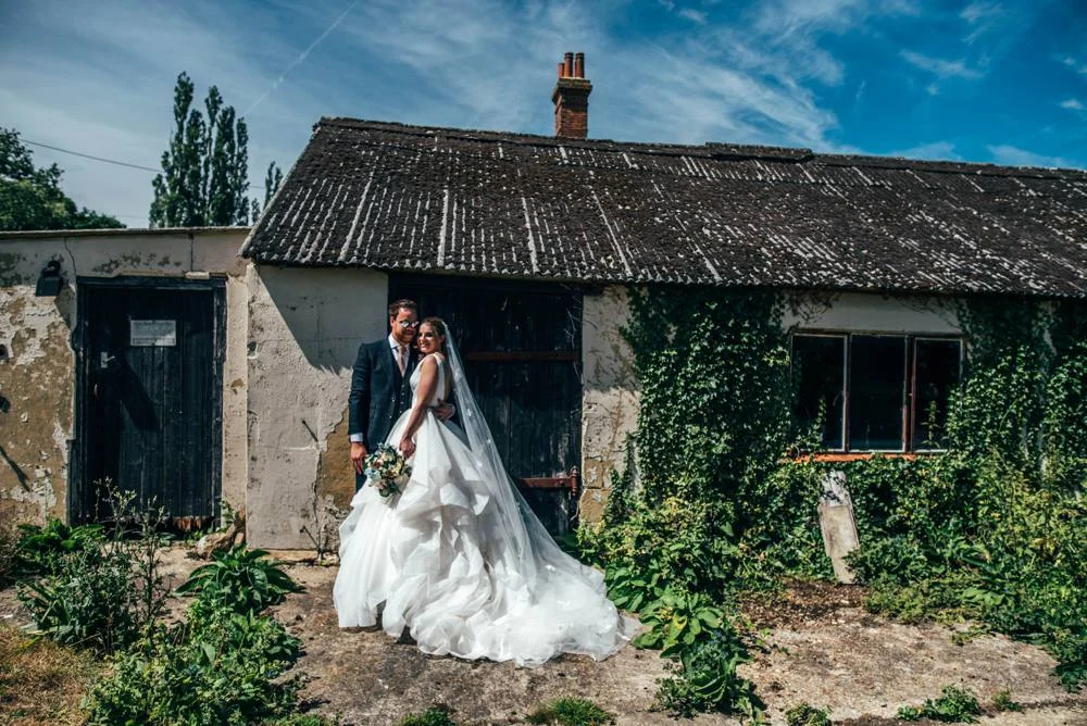 Rustic Summer wedding at Ratsbury Barn with Mini Golf, lawn games, pizza and home-made cake. Bride wears Mori Lee. Essex Documentary Wedding Photographer