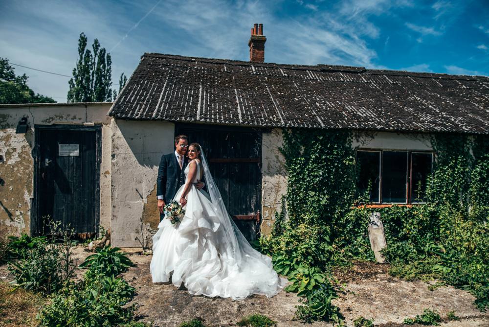 Rustic Summer wedding at Ratsbury Barn with Mini Golf, lawn games, pizza and home-made cake. Bride wears Mori Lee.  Essex Documentary Wedding Photographer