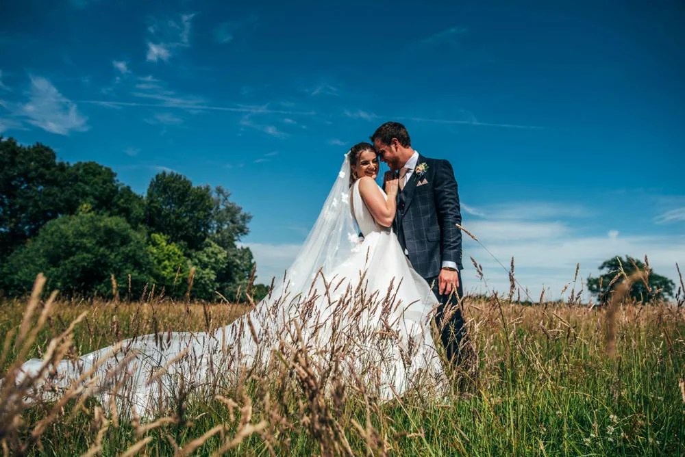 Rustic Summer wedding at Ratsbury Barn with Mini Golf, lawn games, pizza and home-made cake. Bride wears Mori Lee. Essex Documentary Wedding Photographer
