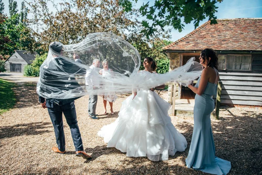 Rustic Summer wedding at Ratsbury Barn with Mini Golf, lawn games, pizza and home-made cake. Bride wears Mori Lee. Essex Documentary Wedding Photographer