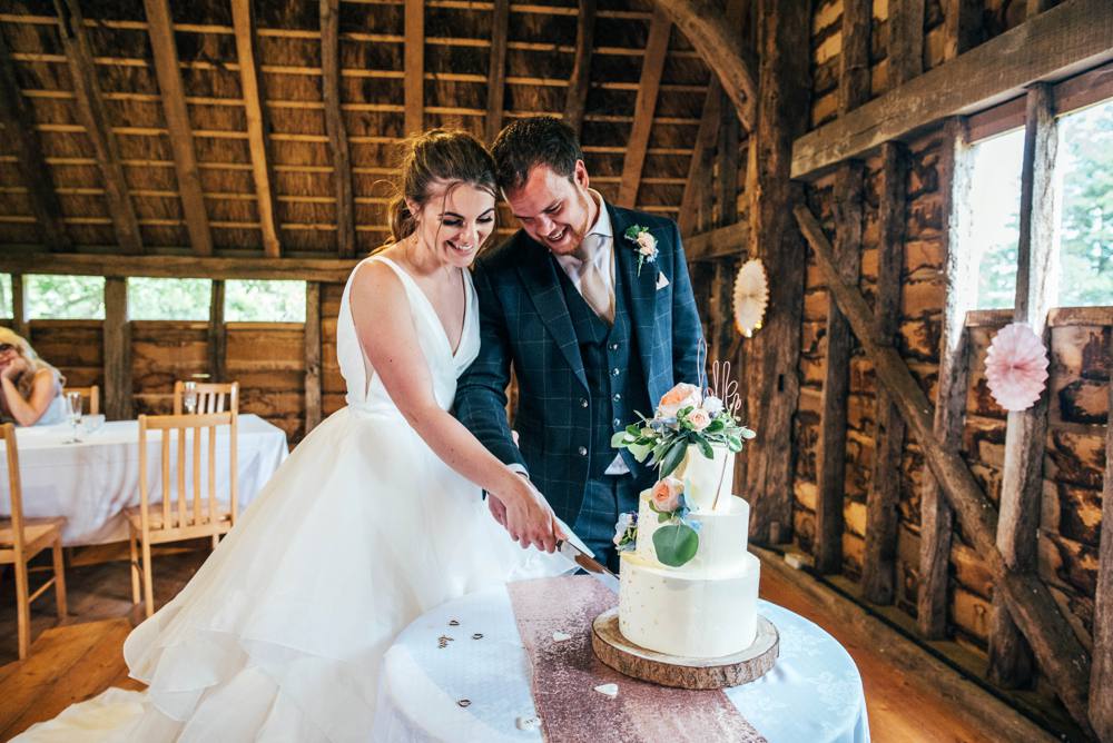 Rustic Summer wedding at Ratsbury Barn with Mini Golf, lawn games, pizza and home-made cake. Bride wears Mori Lee. Essex Documentary Wedding Photographer