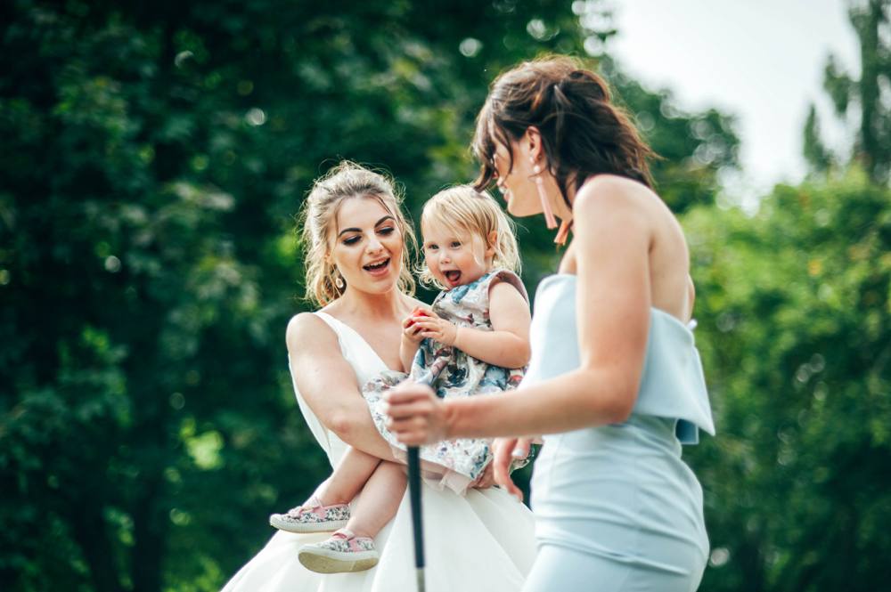 Rustic Summer wedding at Ratsbury Barn with Mini Golf, lawn games, pizza and home-made cake. Bride wears Mori Lee. Essex Documentary Wedding Photographer