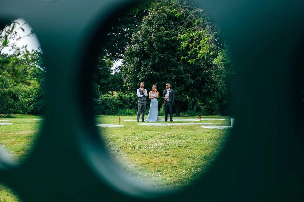 Rustic Summer wedding at Ratsbury Barn with Mini Golf, lawn games, pizza and home-made cake. Bride wears Mori Lee. Essex Documentary Wedding Photographer