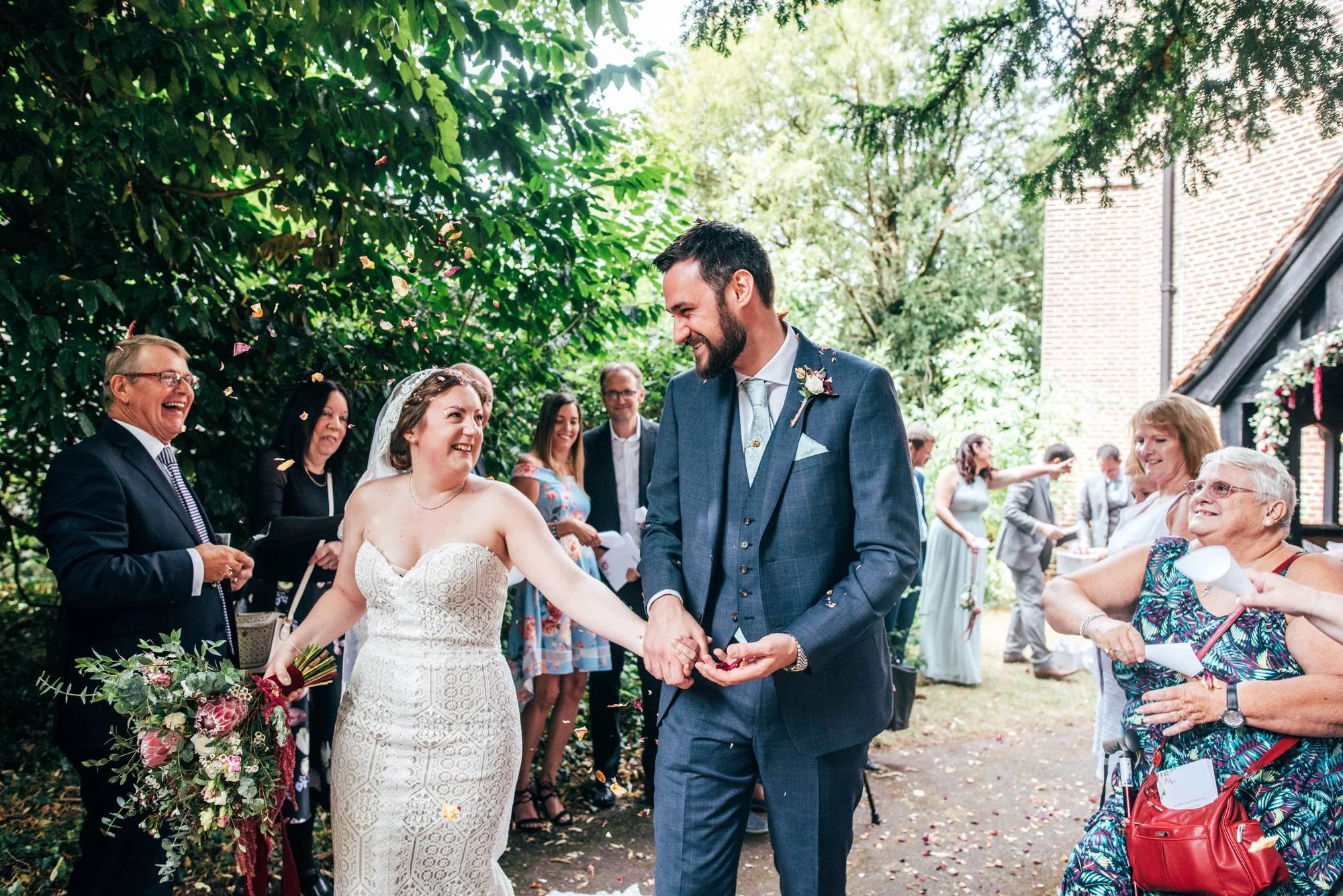 East Anglian Railway Museum Wedding. Vintage lace with Red &amp; Light Blue Palette with Proteas Bouquet. Essex Documentary Wedding Photographer