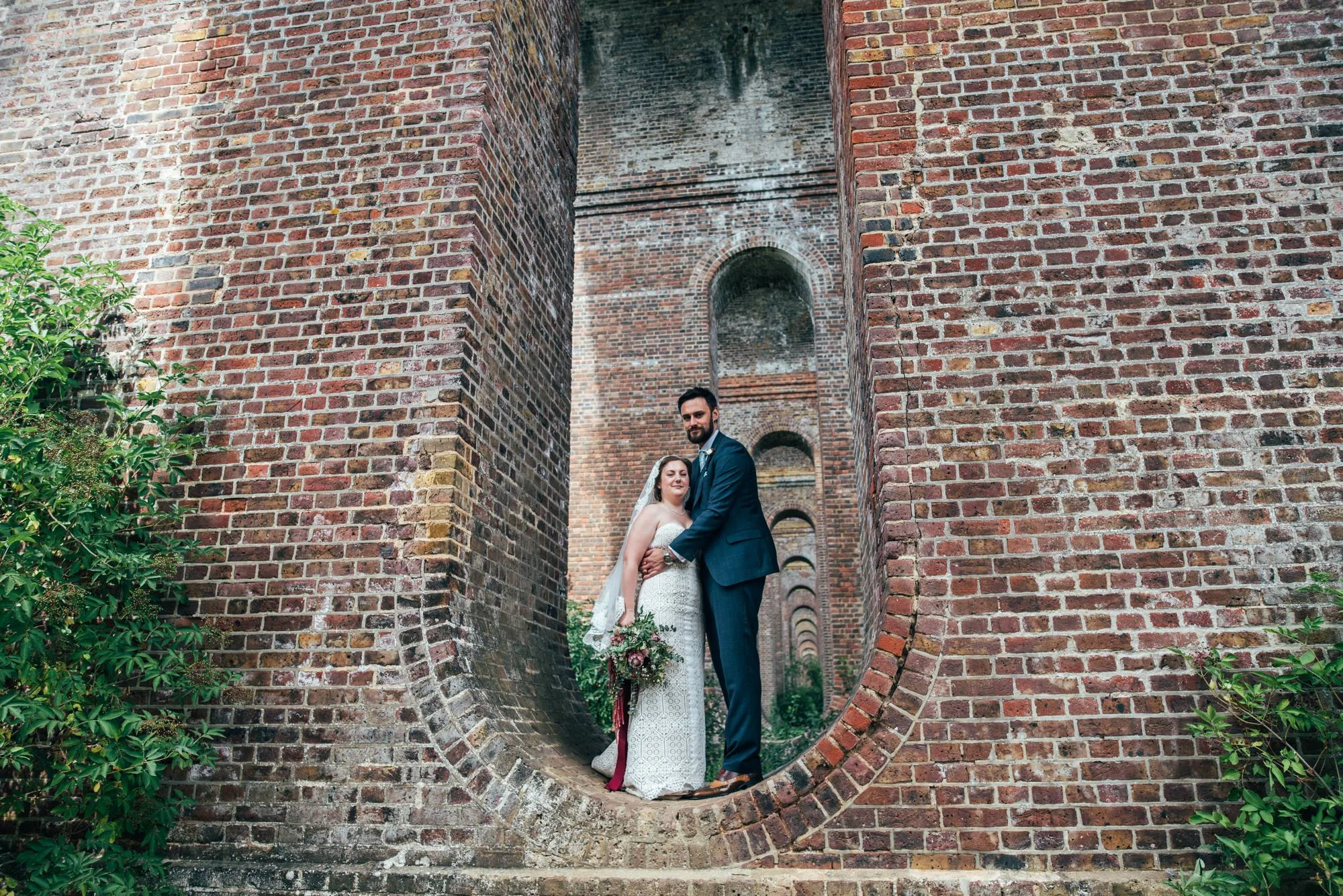East Anglian Railway Museum Wedding. Vintage lace with Red &amp; Light Blue Palette with Proteas Bouquet. Essex Documentary Wedding Photographer