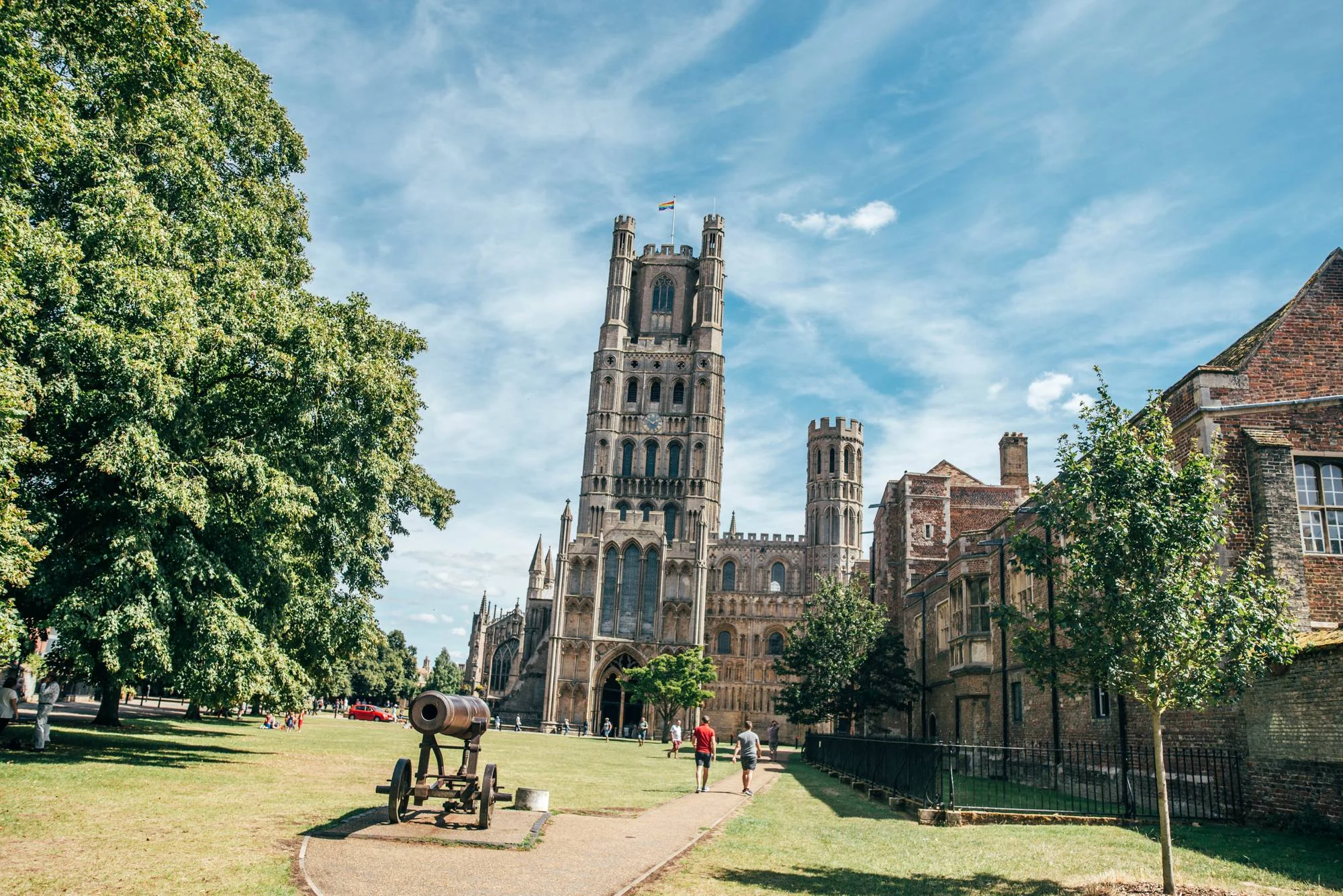 Ely Cathedral with a DIY, Boho Farm Wedding Reception at Bedingham's Farm , Bride wears Willowby by Watters and a Flower Crown. Essex Documentary Wedding Photographer.
