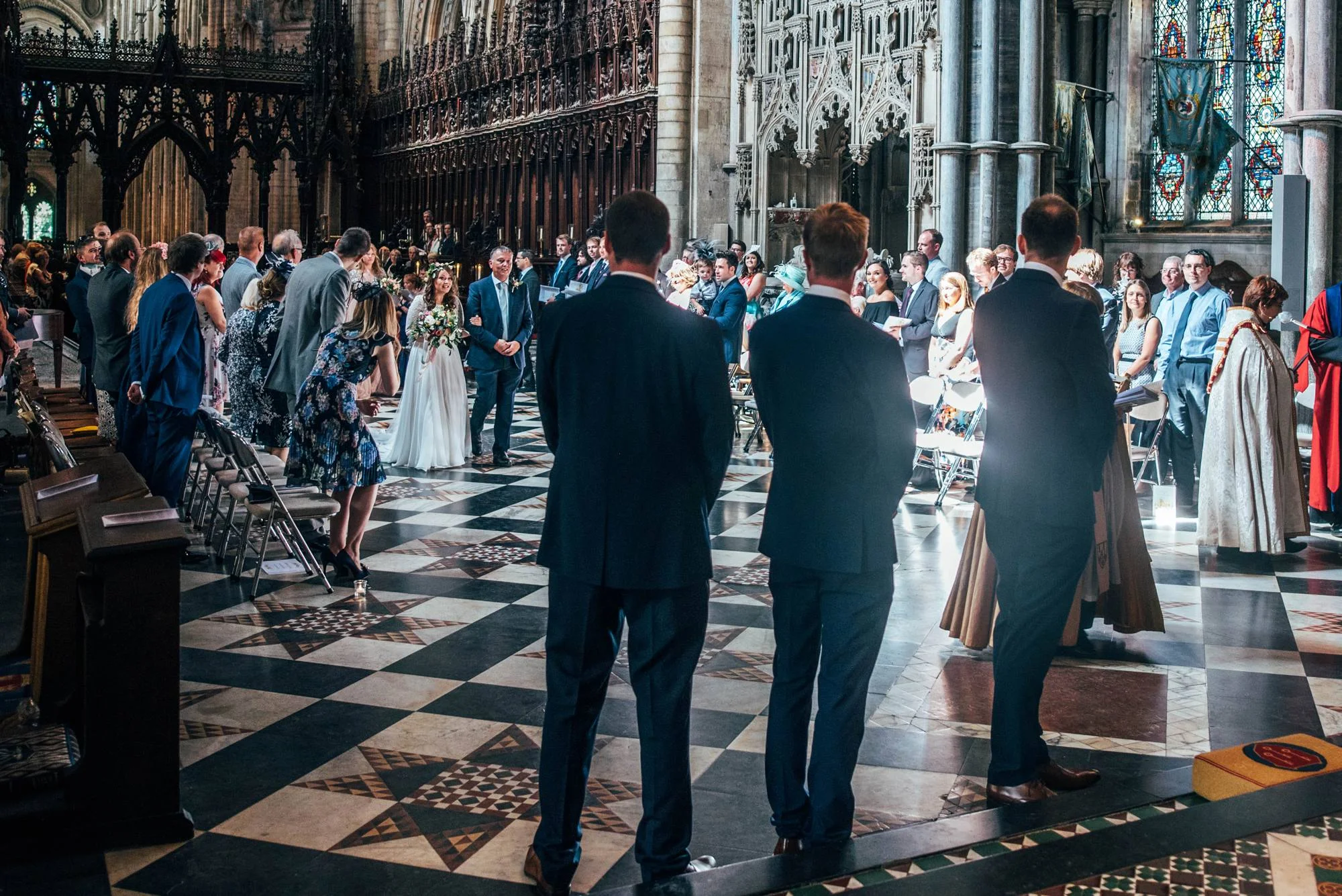 Ely Cathedral with a DIY, Boho Farm Wedding Reception at Bedingham's Farm , Bride wears Willowby by Watters and a Flower Crown. Essex Documentary Wedding Photographer.