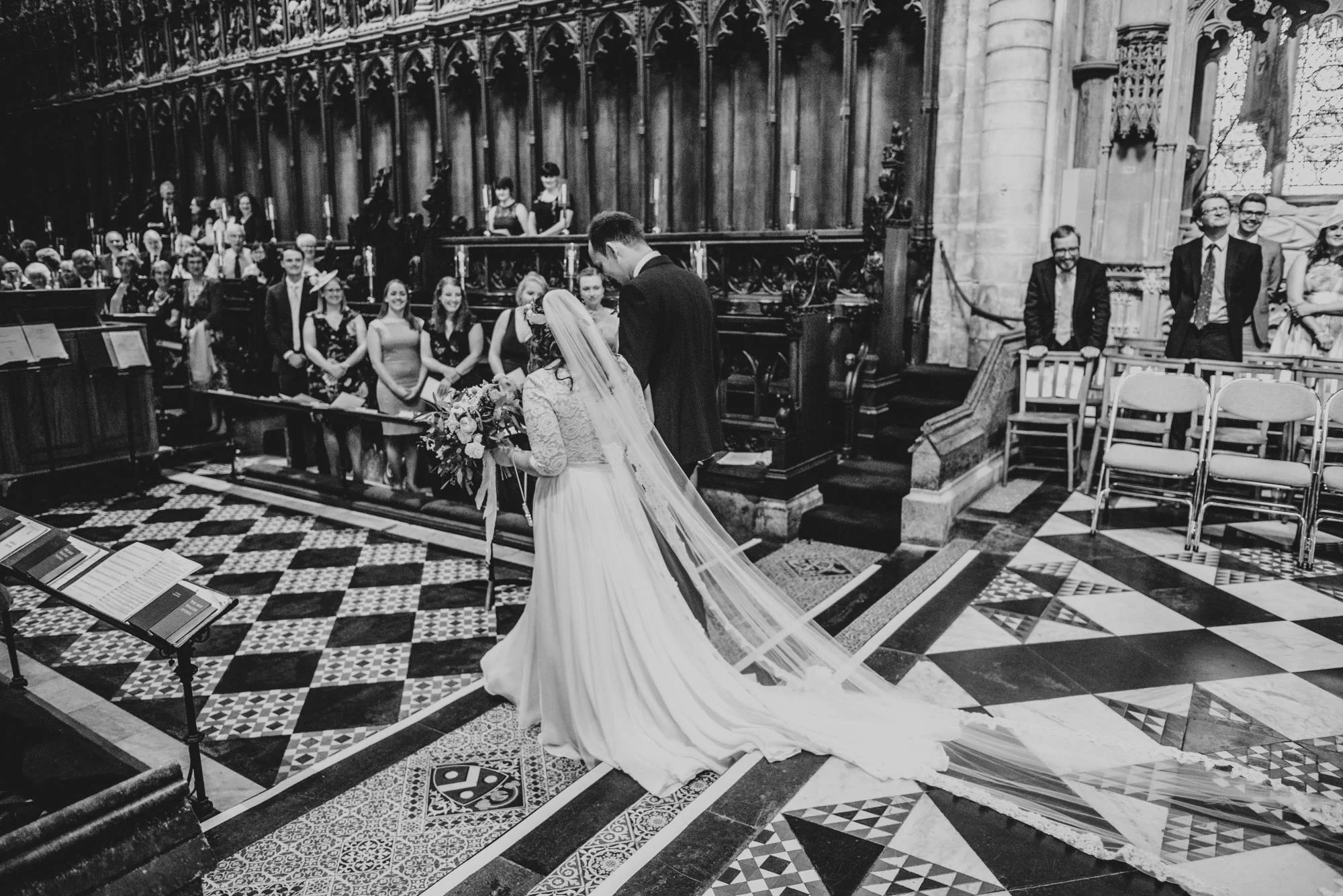 Ely Cathedral with a DIY, Boho Farm Wedding Reception at Bedingham's Farm , Bride wears Willowby by Watters and a Flower Crown. Essex Documentary Wedding Photographer.