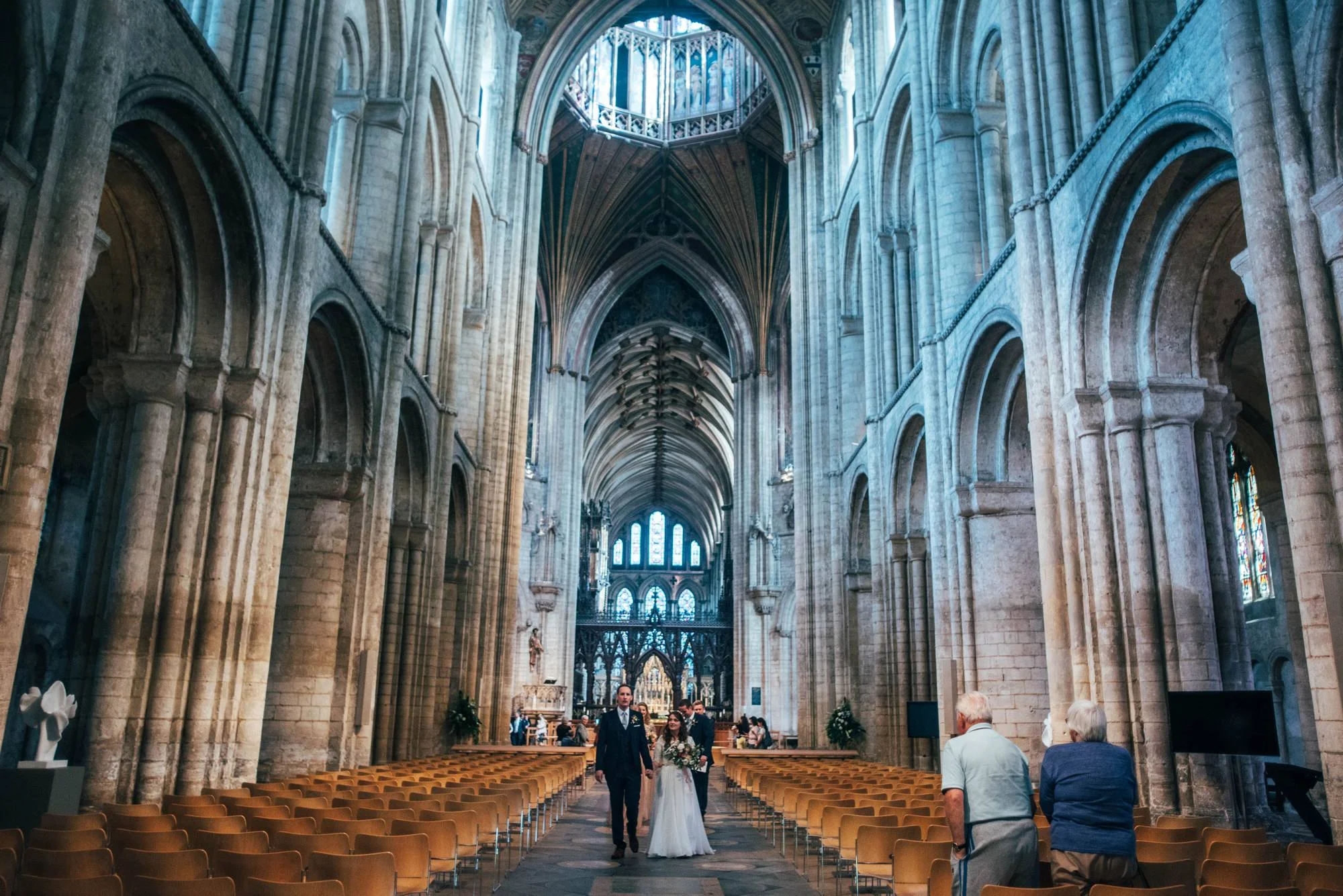 Ely Cathedral with a DIY, Boho Farm Wedding Reception at Bedingham's Farm , Bride wears Willowby by Watters and a Flower Crown. Essex Documentary Wedding Photographer.