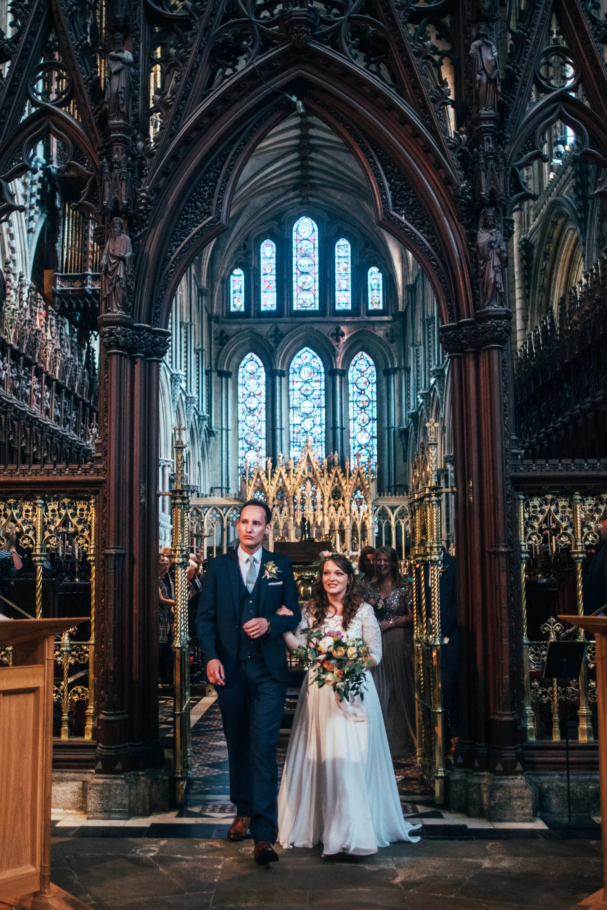 Ely Cathedral with a DIY, Boho Farm Wedding Reception at Bedingham's Farm , Bride wears Willowby by Watters and a Flower Crown. Essex Documentary Wedding Photographer.