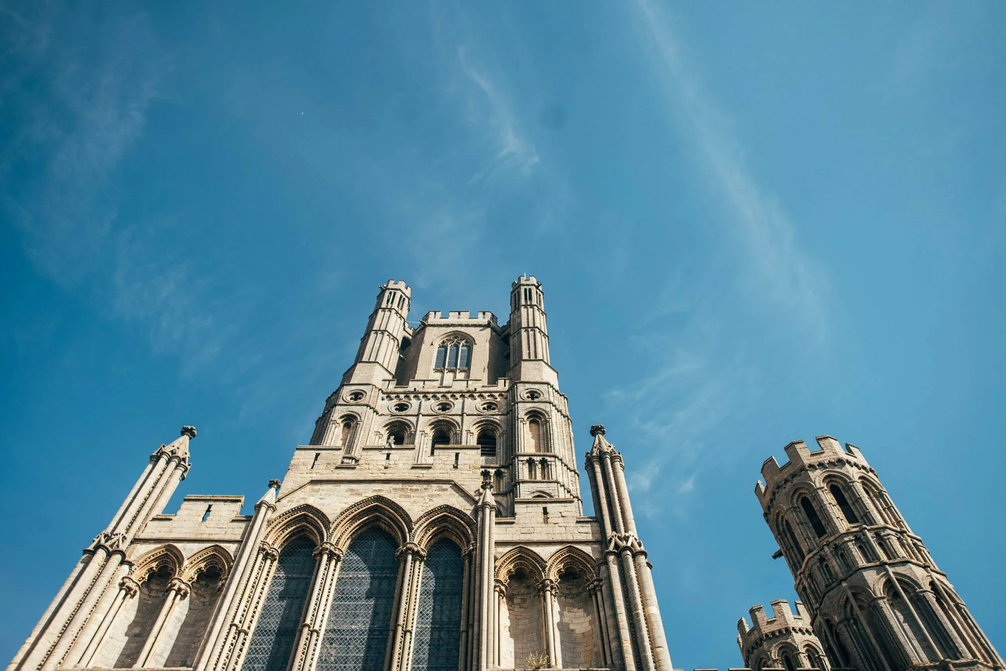 Ely Cathedral with a DIY, Boho Farm Wedding Reception at Bedingham's Farm , Bride wears Willowby by Watters and a Flower Crown. Essex Documentary Wedding Photographer.
