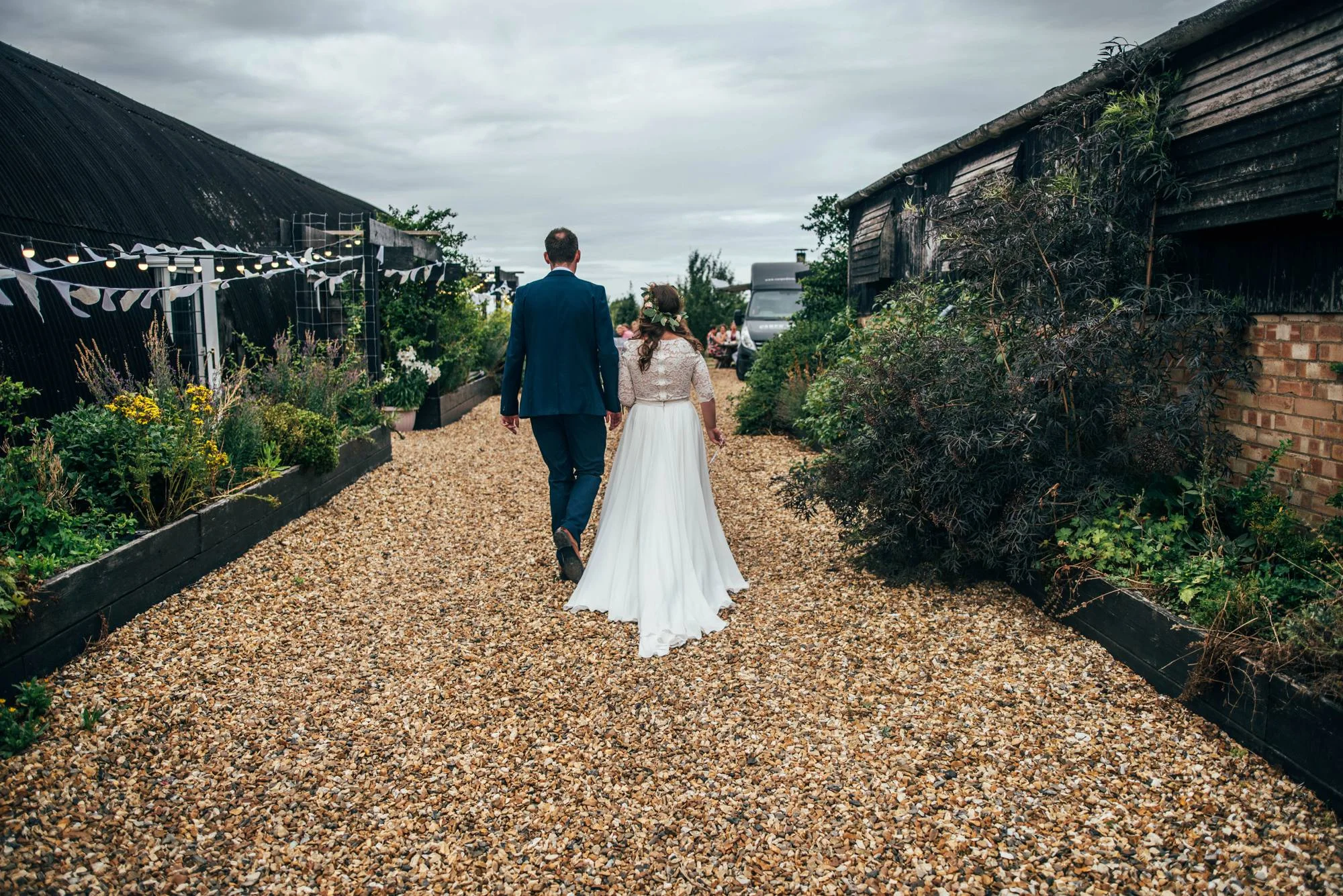 Ely Cathedral with a DIY, Boho Farm Wedding Reception at Bedingham's Farm , Bride wears Willowby by Watters and a Flower Crown. Essex Documentary Wedding Photographer.