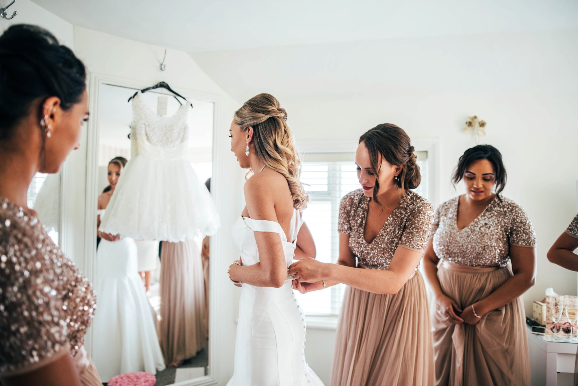 Traditional Wedding with a Modern Flavour at Fennes, Braintree with Bridesmaids in Blush Sequins and Groomsmen in Blue.  Bride wears Essence. Essex Documentary Wedding Photographer.