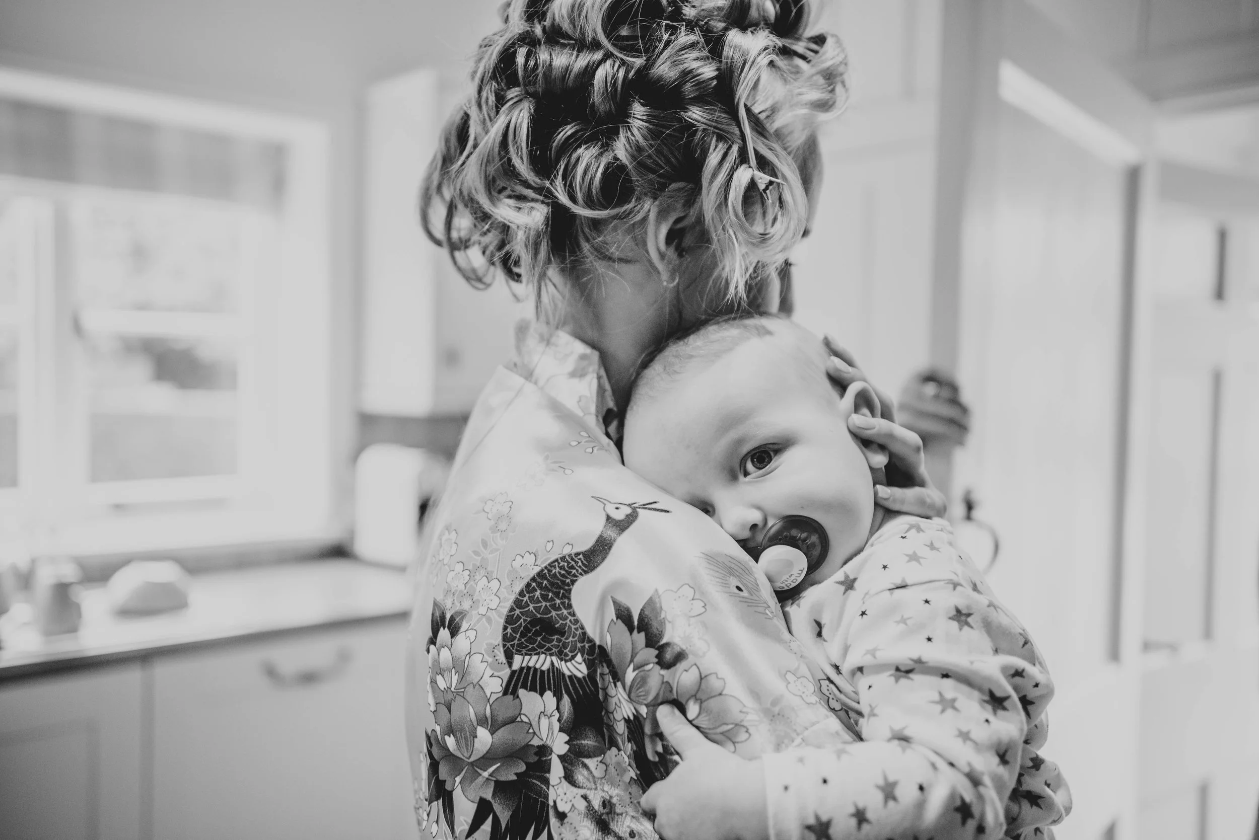 Baby cuddles Bride at Blake Hall, Ongar, Essex Documentary Wedding Photographer