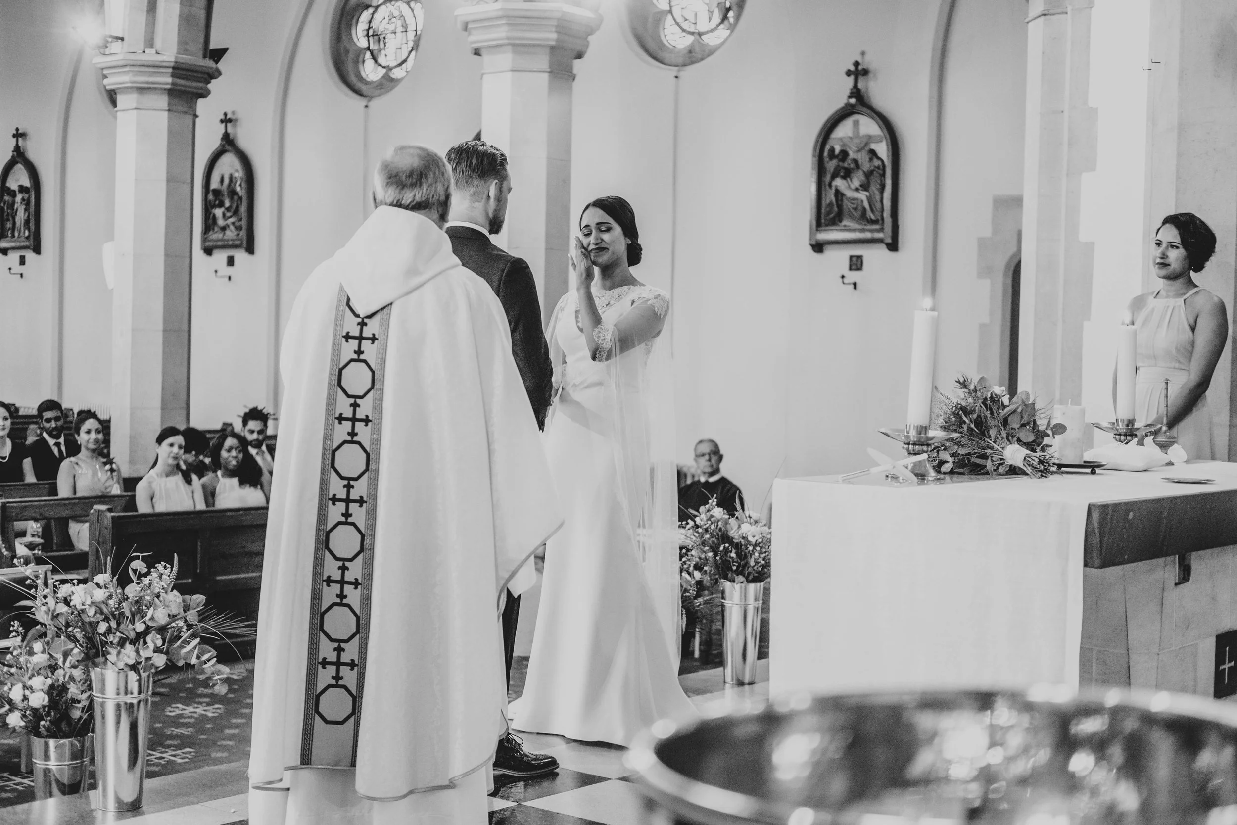 Bride wipes away tear during ceremony in East London Church, Essex Documentary Wedding Photographer 