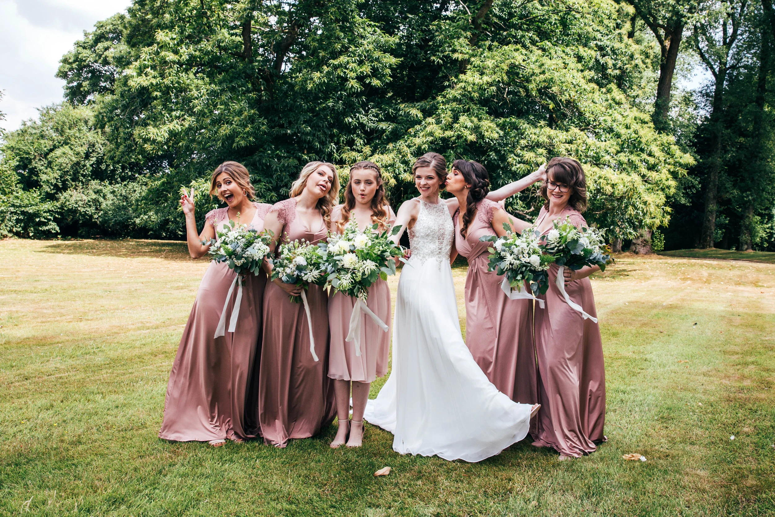 Playful bride and bridesmaids at The Long Barn.  Essex Documentary Wedding Photographer