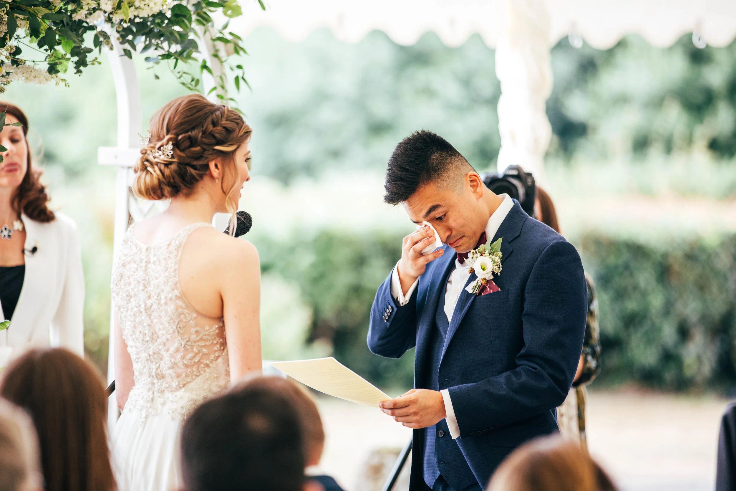 Groom wipes away tear during ceremony at The Long Barn, Essex Documentary Wedding Photographer
