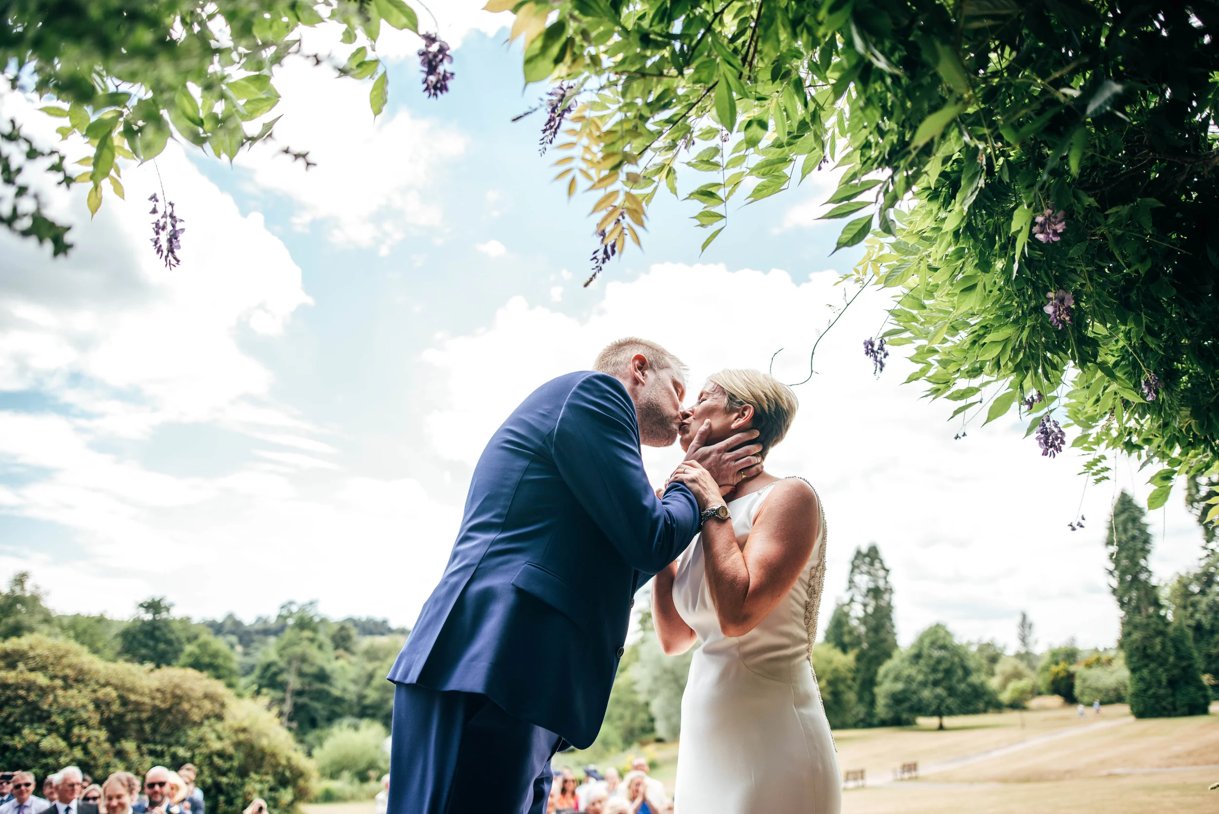 Bride and Groom kiss, lawn ceremony at Ashdown Park Hotel, Essex Documentary Wedding Photographer