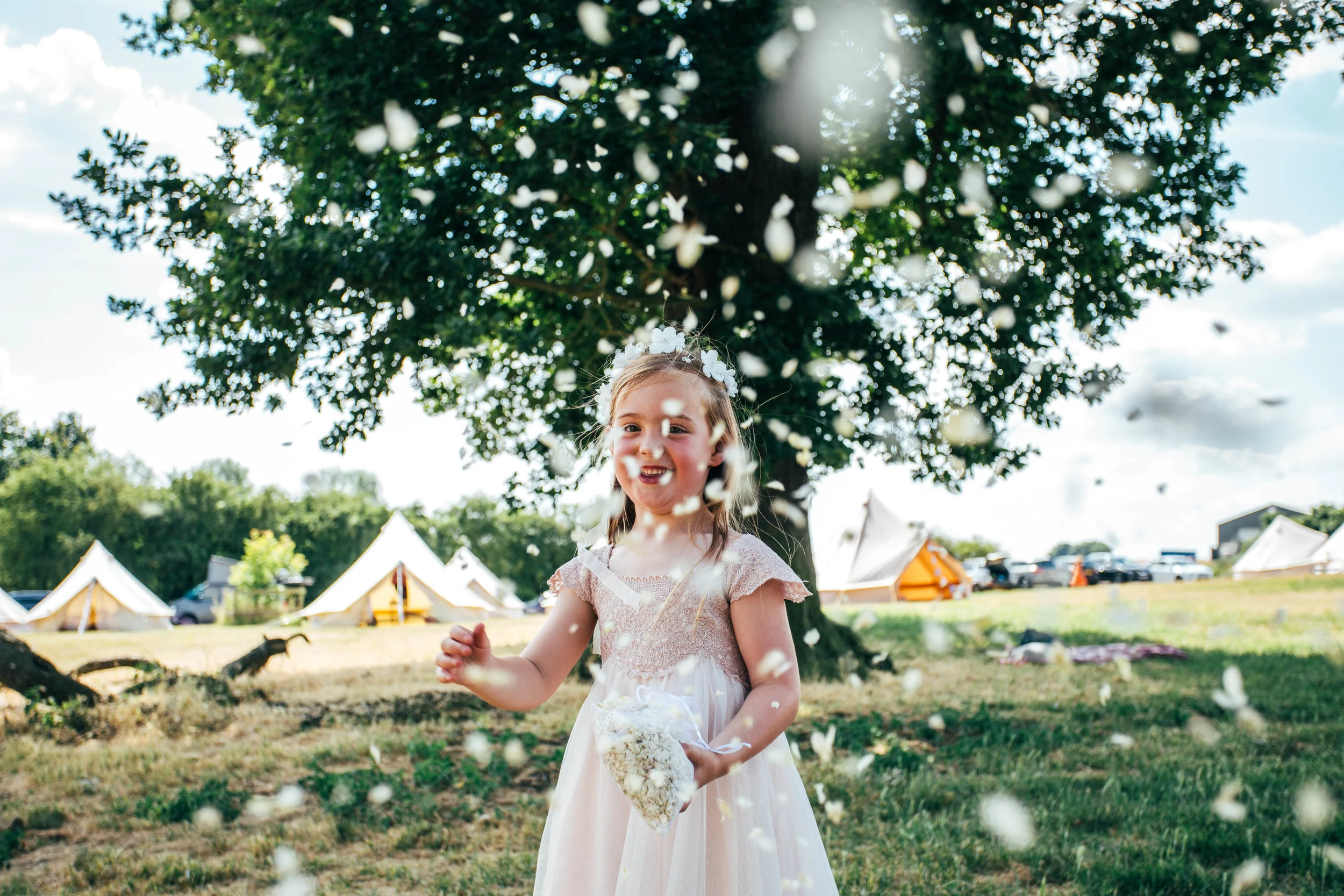 Flower Girl throws confetti at camera, DIY Boho Wedding, Essex Documentary Wedding Photographer
