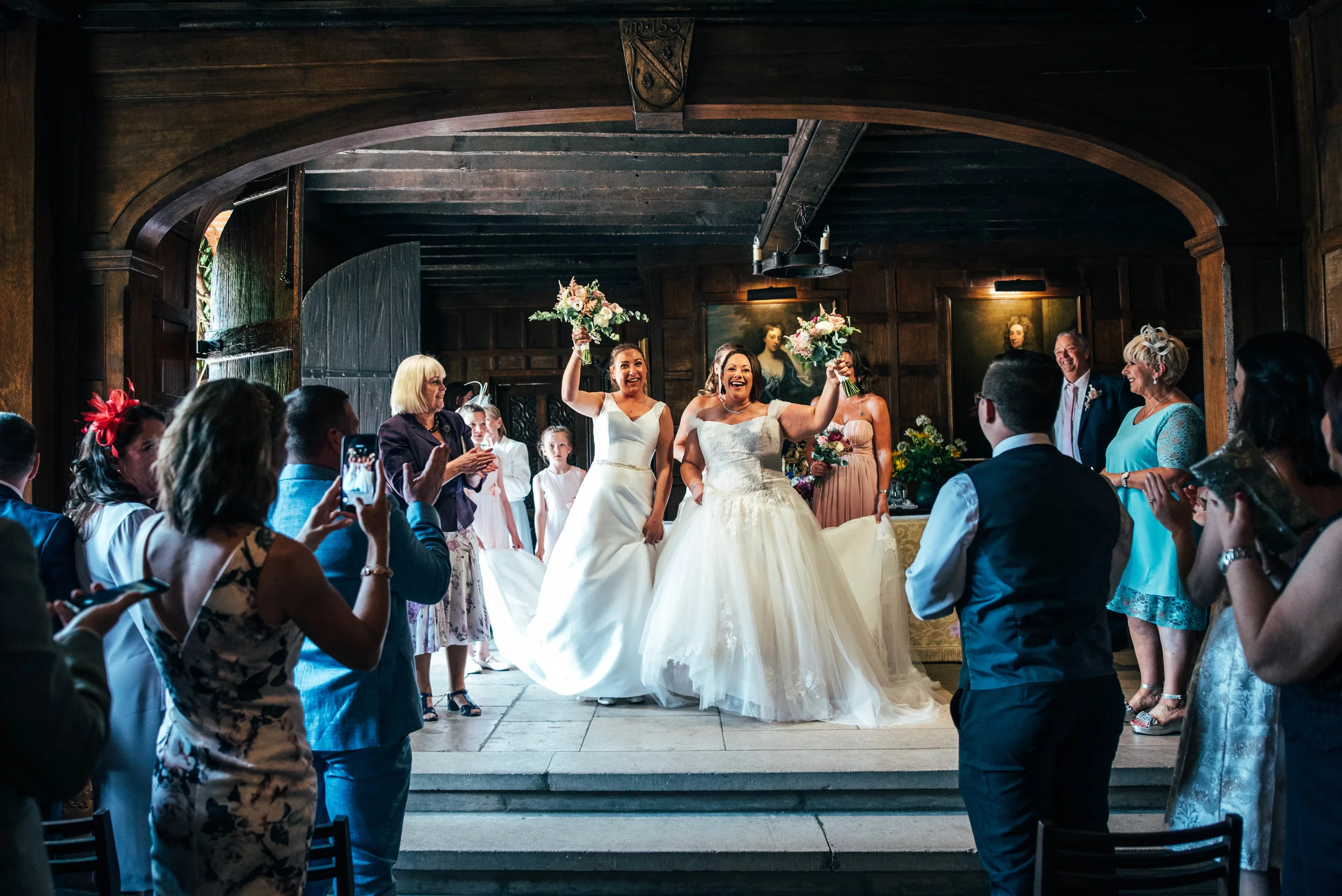 Bride and Bride celebrate after ceremony at Ingatestone Hall, Essex Documentary Wedding Photographer