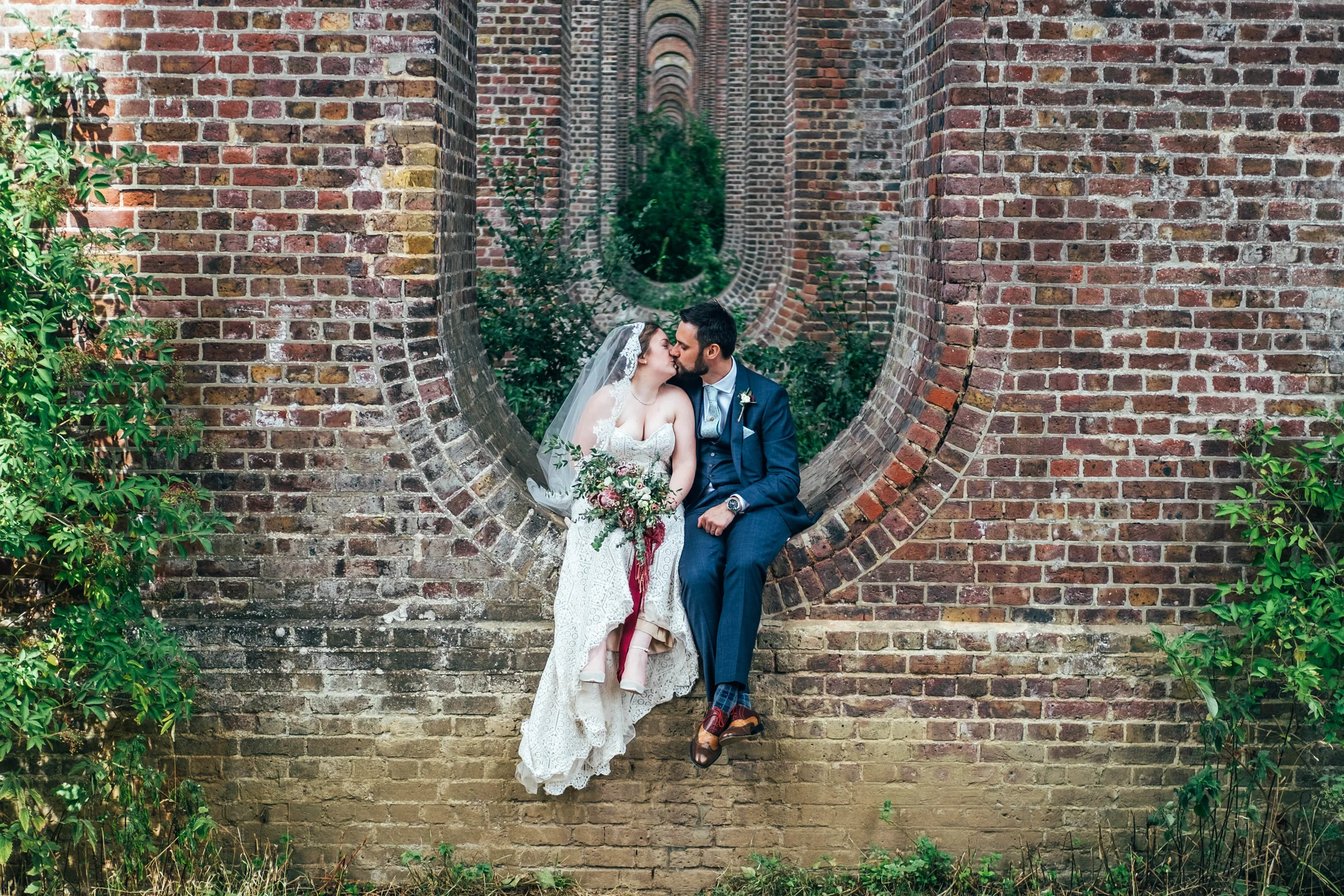 Bride &amp; Groom in Viaduct at Chappel for East Anglian Railway Museum Wedding Essex Documentary Wedding Photographer