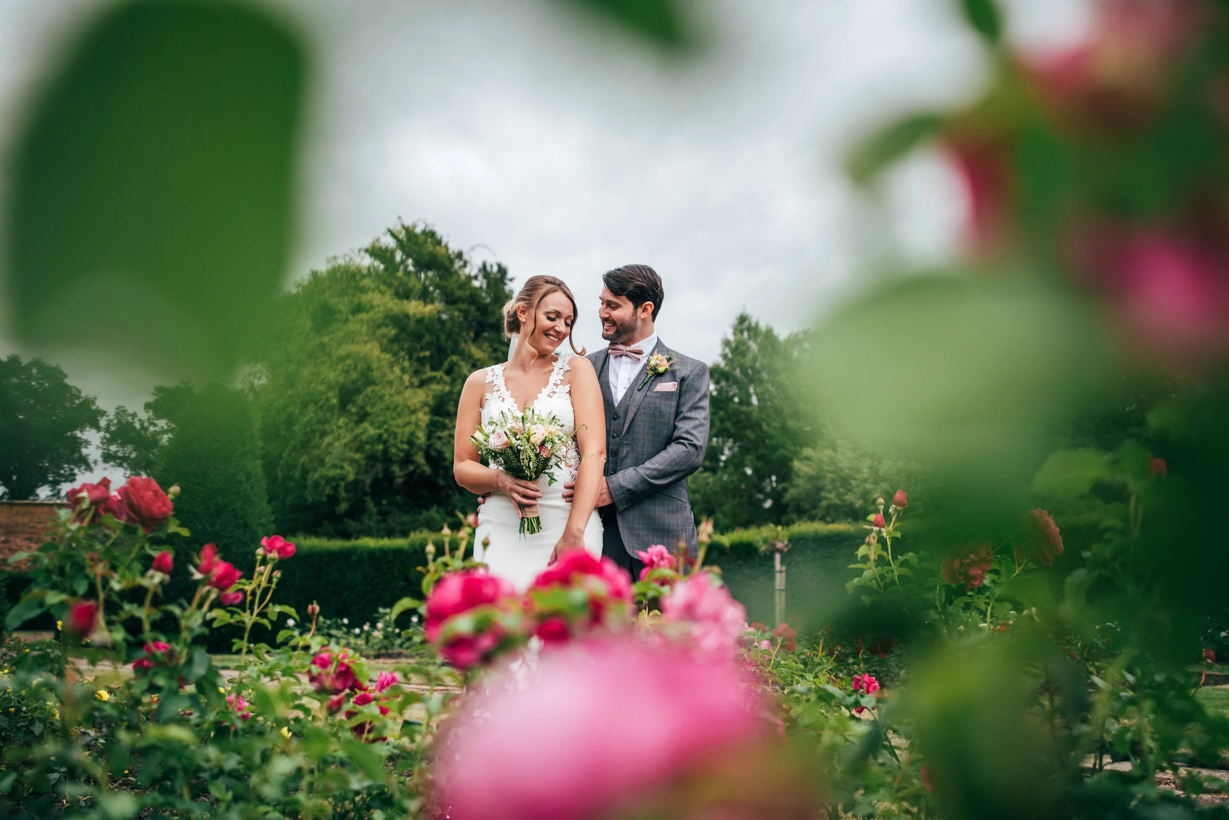 Bride and Groom in Rose Garden at Blake Hall, Ongar Essex Documentary Wedding Photographer 