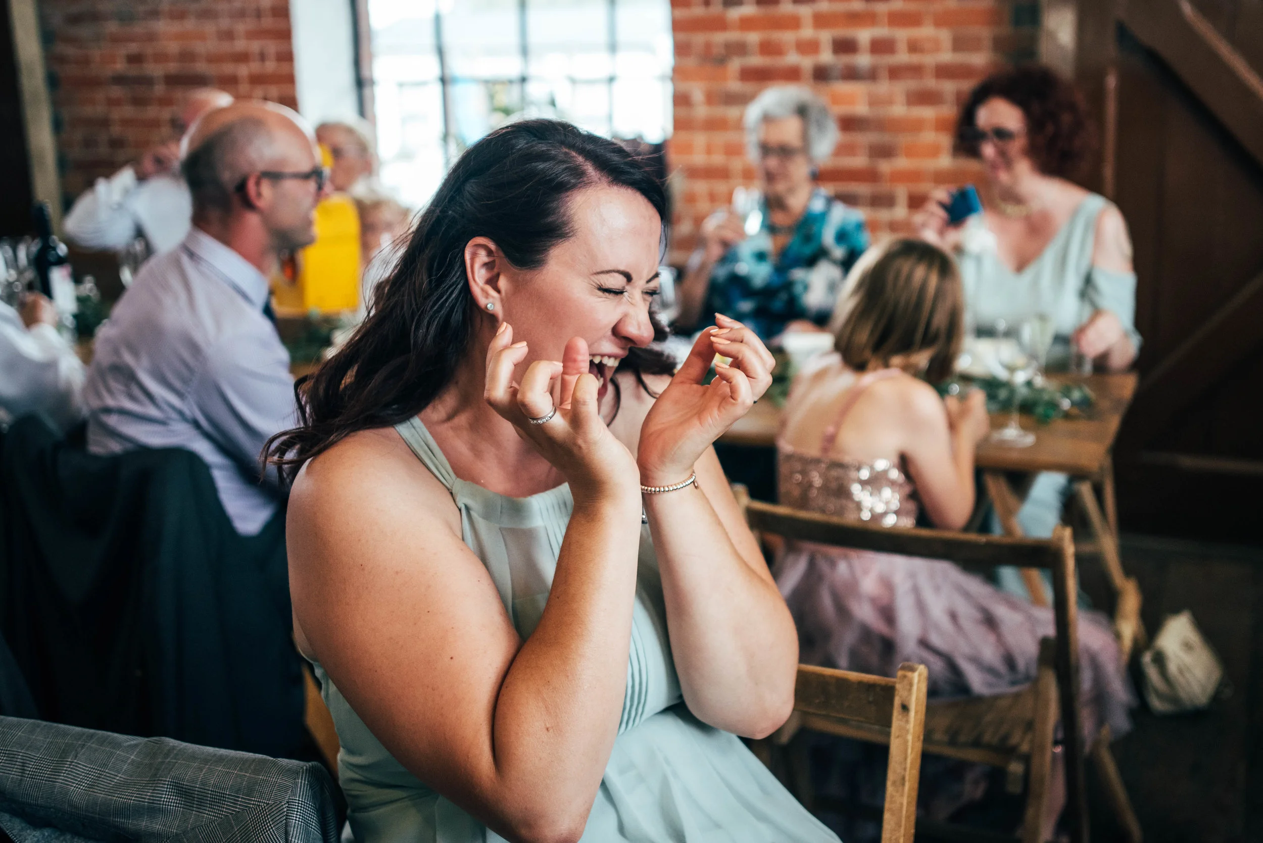 Bridesmaid pulls face after drinking a shot East Anglian Railway Museum Wedding Essex Documentary Wedding Photographer