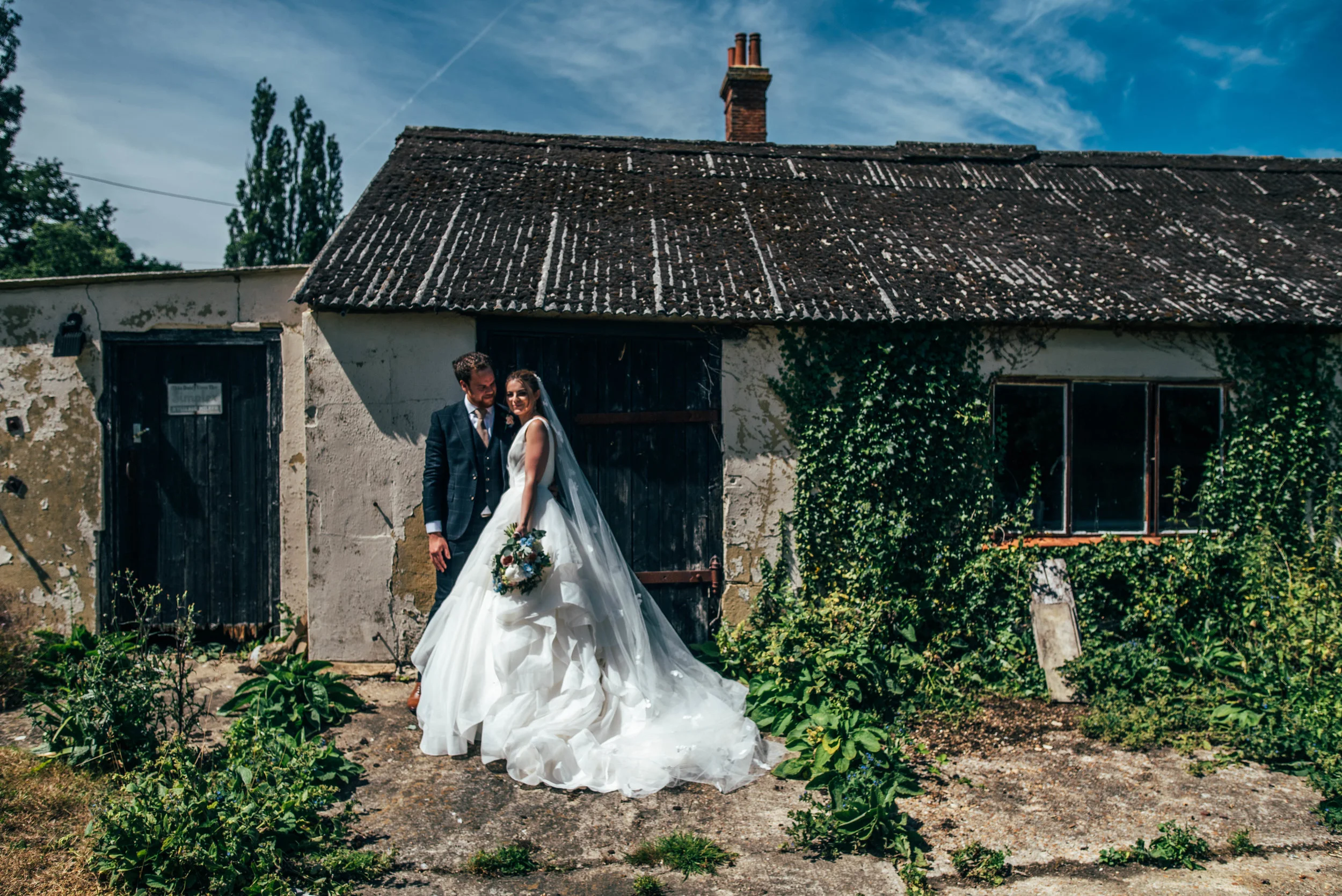 Bride and Groom by derelict outbuilding at Ratsbury Barn, Essex Documentary Wedding Photographer 