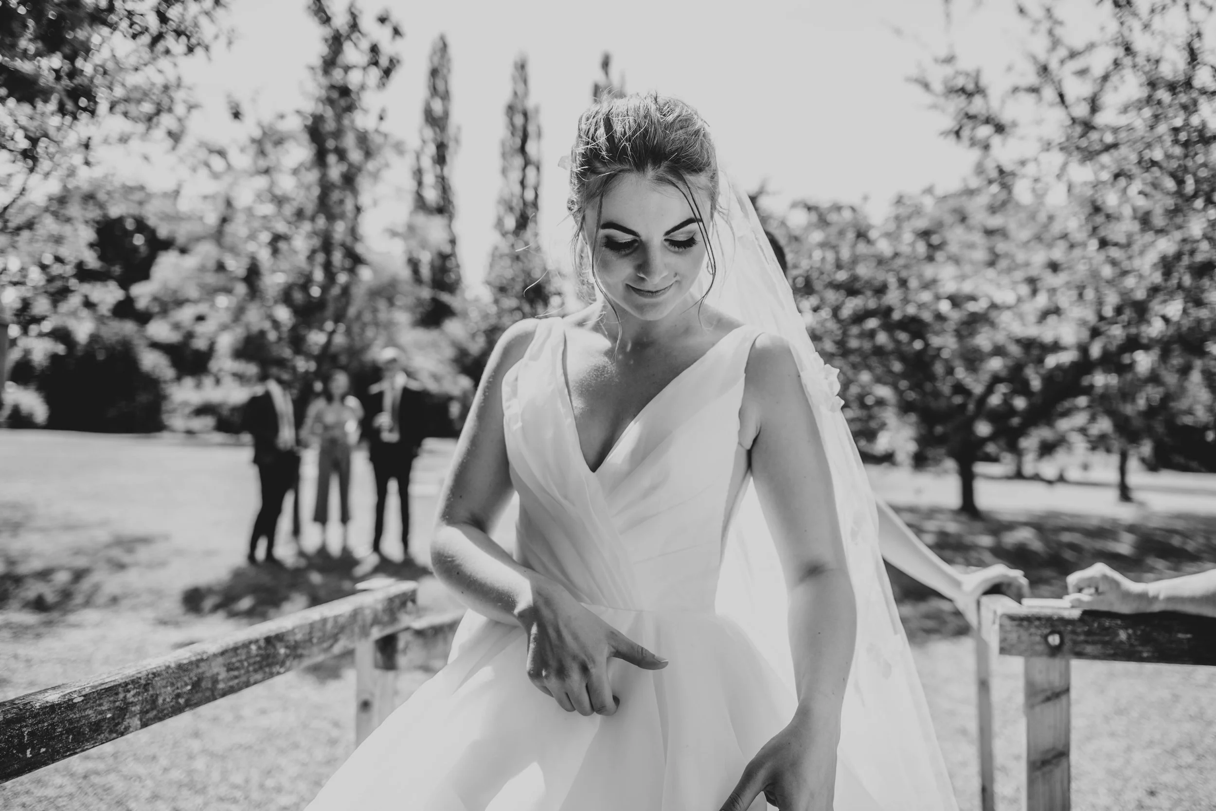 Bride admires dress in the sun at Ratsbury Barn, Essex Documentary Wedding Photographer
