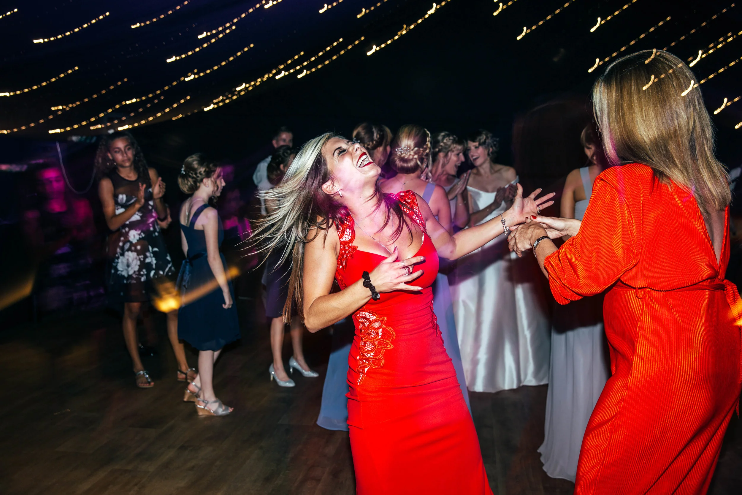Wedding guest rocks out on dance floor at Hedingham Castle, Essex Documentary Wedding Photographer