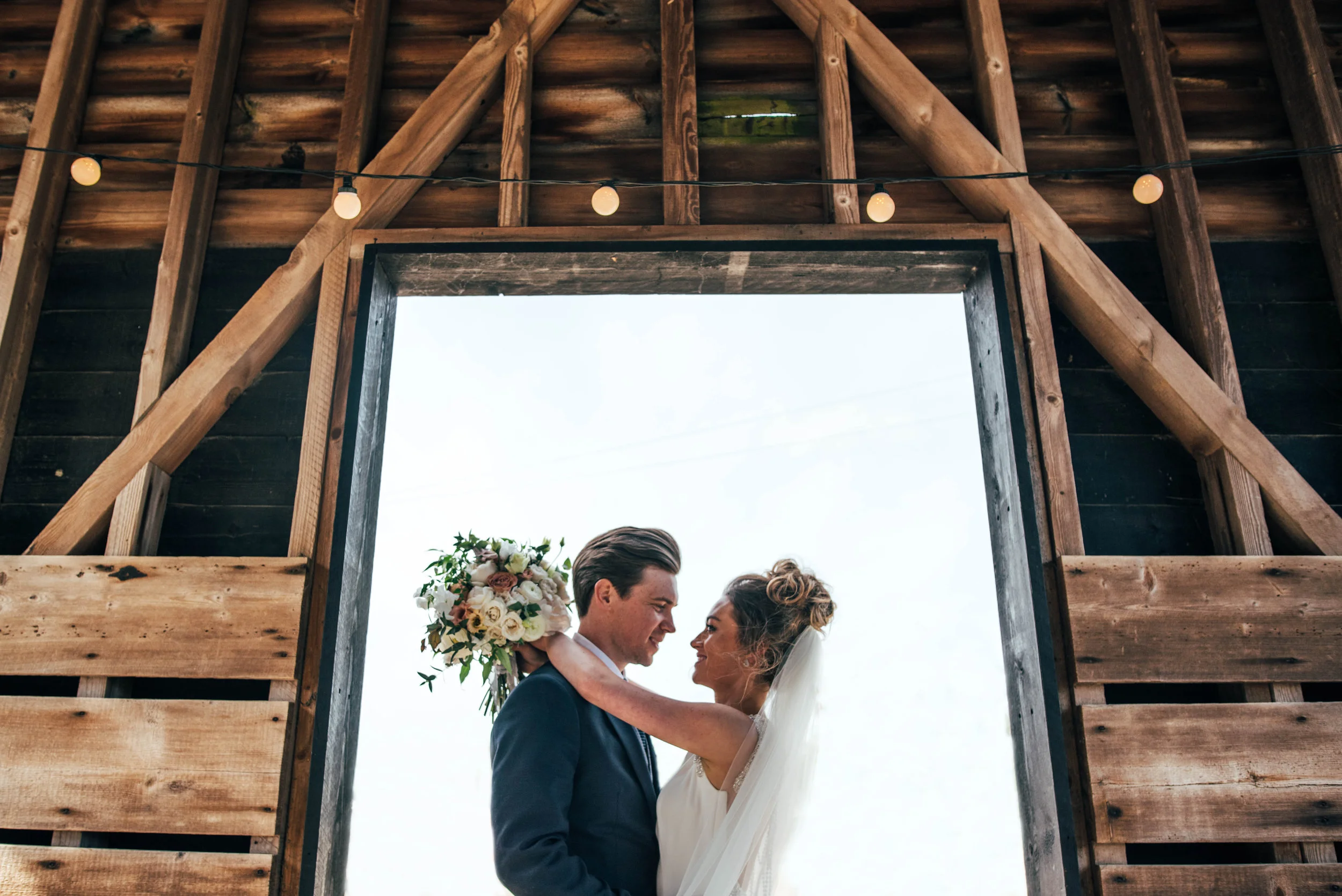 Bride and Groom in Barn Doorway at Gaynes Park Epping Essex Documentary Wedding Photographer