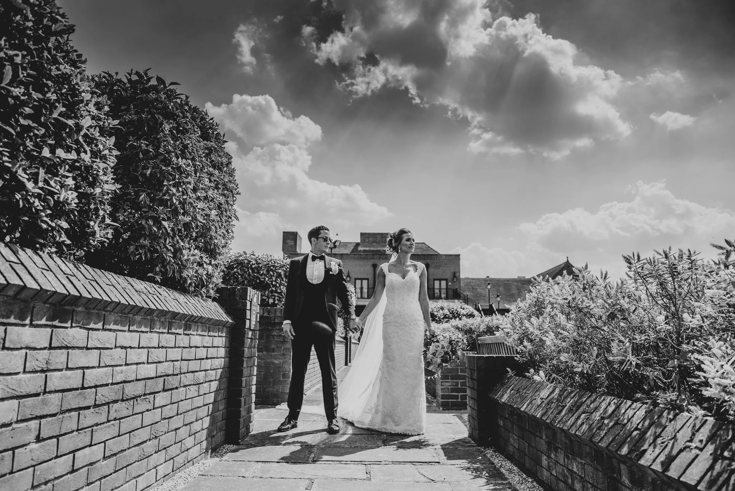 Bride & Groom under dramatic clouds at Stockbrook Manor Essex Documentary Wedding Photographer