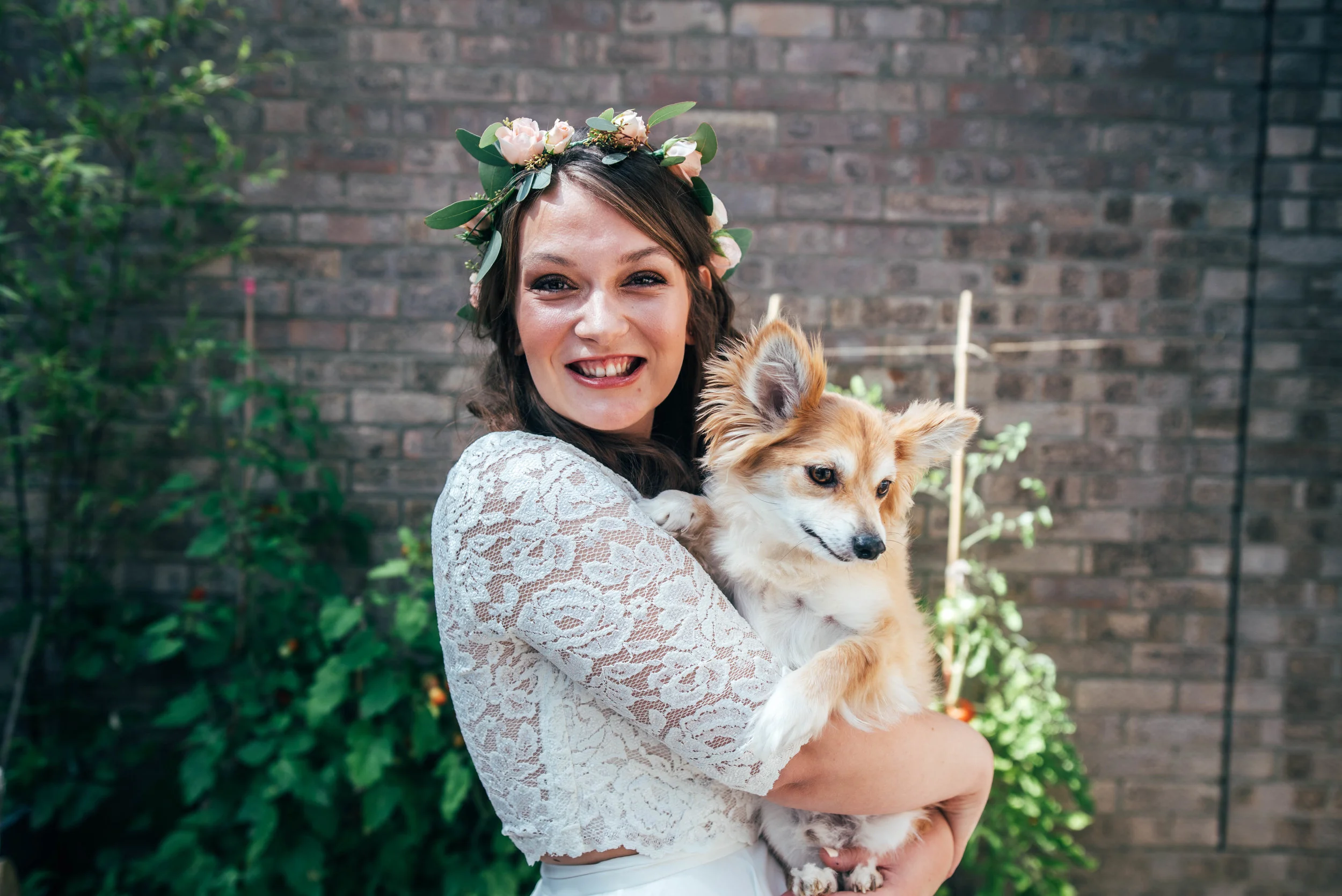 Bride in Flower Crown cuddles her dog Essex Documentary Wedding Photographer