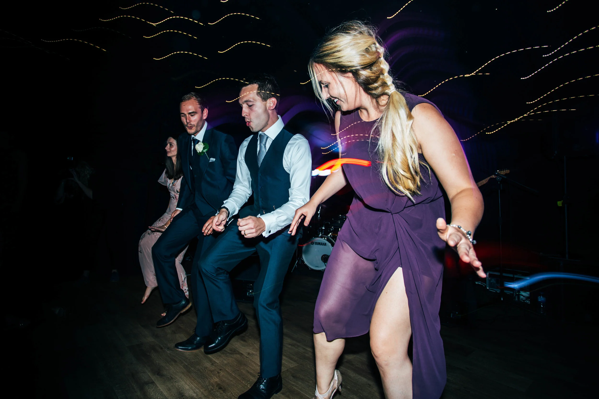 Groom and guests dancing at Hedingham Castle Essex Documentary Wedding Photographer