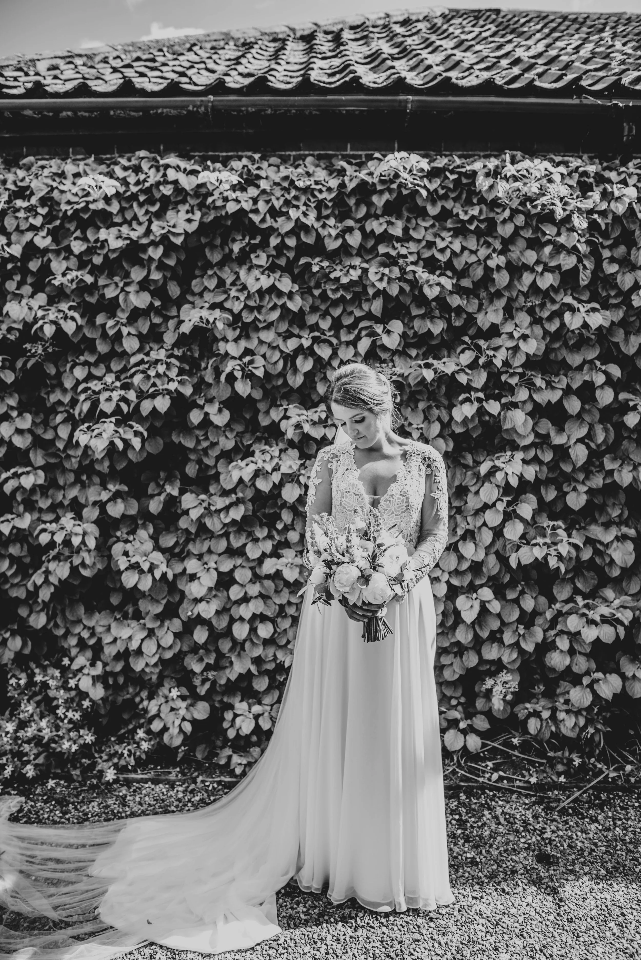Bride in the gardens at The Granary Estates. Essex documentary wedding photographer. Three Flowers Photography