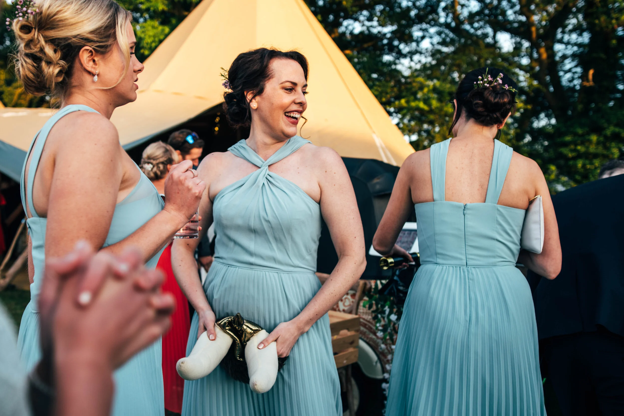 Bridesmaids has a joke with a Viking hat prop at Back Garden DIY Tipi Wedding. Essex Documentary Wedding Photographer. Three Flowers Photography