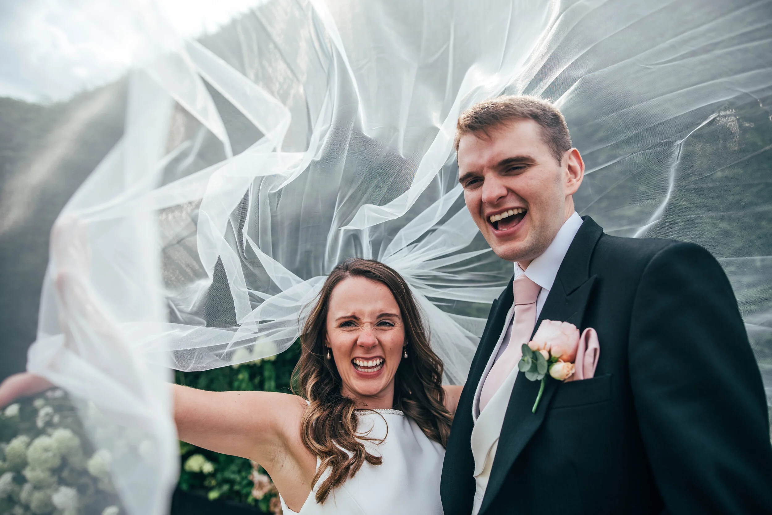 Laughing Bride & Groom under billowing veil. Gaynes Park Wedding. Essex Documentary Wedding Photographer. Three Flowers Photography