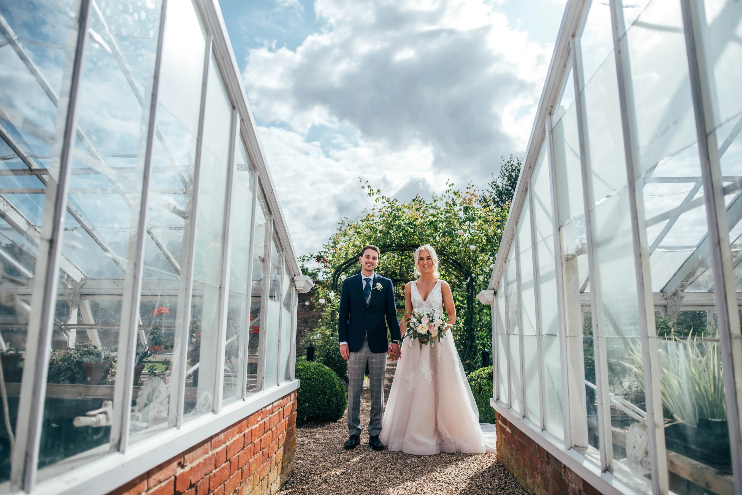 Bride & Groom and Greenhouses at Braxted Park Wedding. Essex Documentary Wedding Photographer. Three Flowers Photography