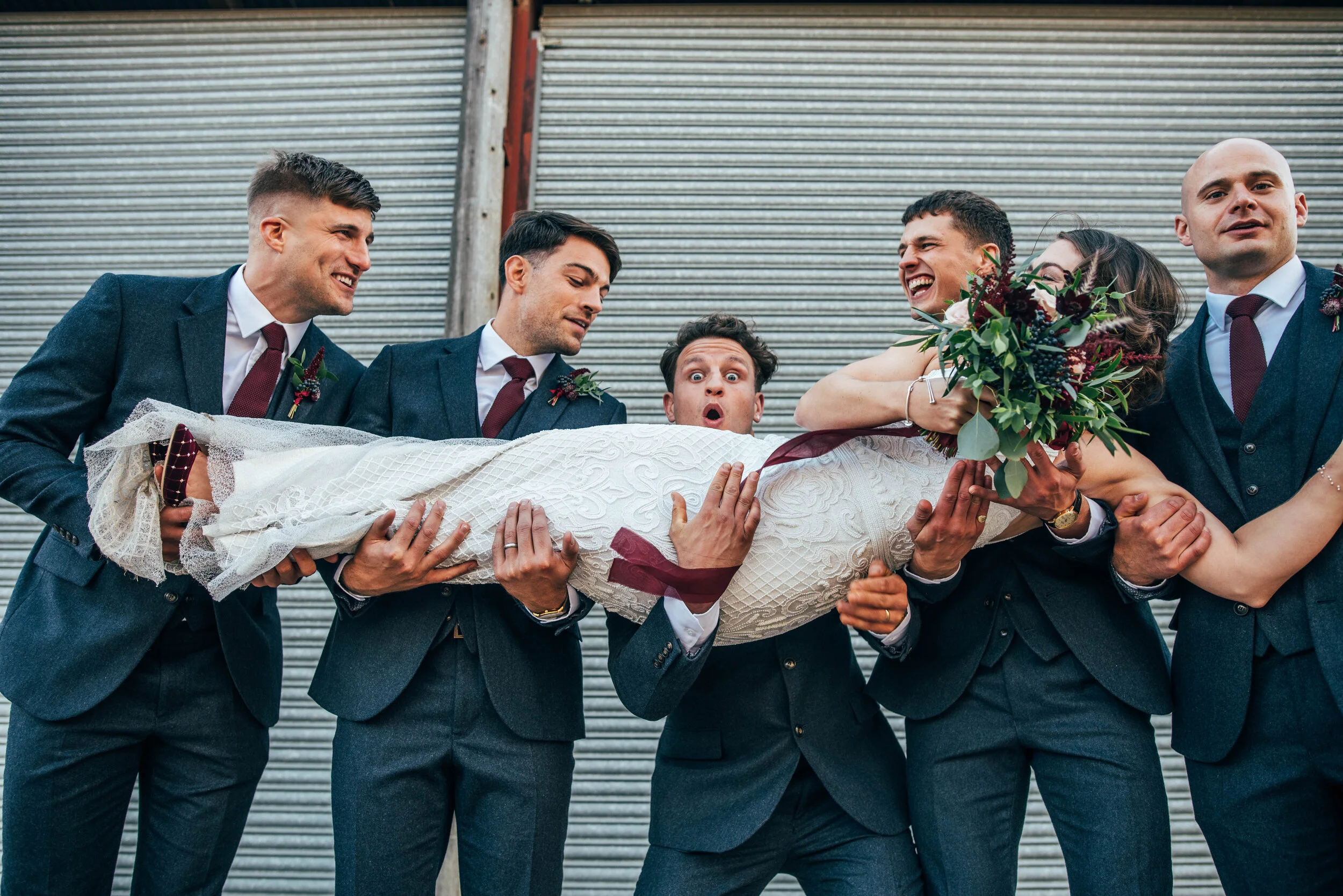 Groomsmen lift Bride at Farm Barn Wedding. The Barns at Lodge Farm. Essex Documentary Wedding Photographer. Three Flowers Photography