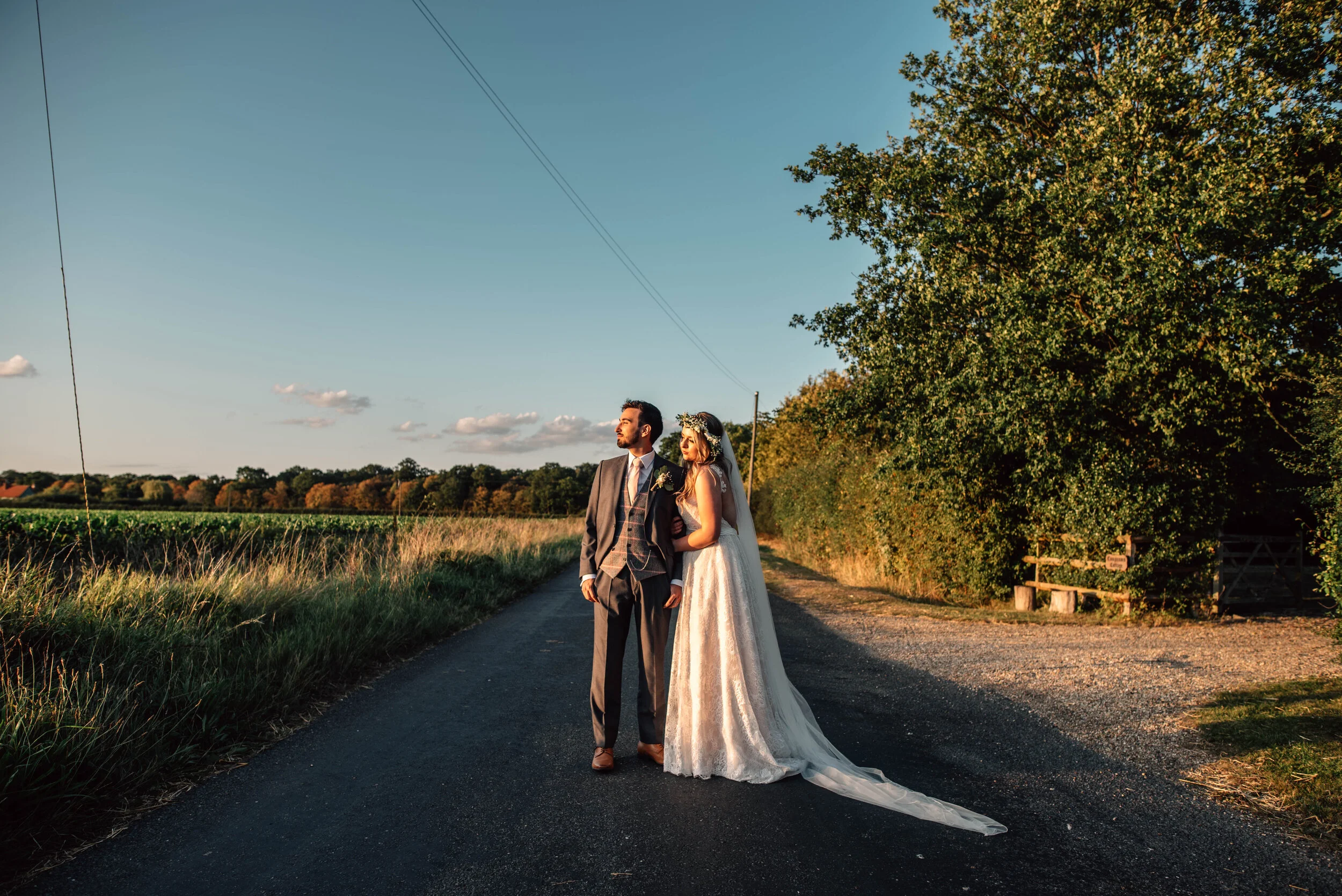 Bride & Groom in road at sunset.  The Compasses Pattiswick. Essex documentary wedding photographer. Three Flowers Photography