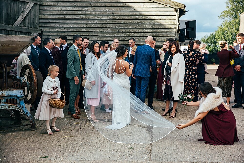 Autumn reds at The Barns at Lodge Farm with pet doggies, Irish folk music, cheesecake & budgie smugglers. Bride wears Rosa Clara & Valentino. Essex Documentary Wedding Photographer