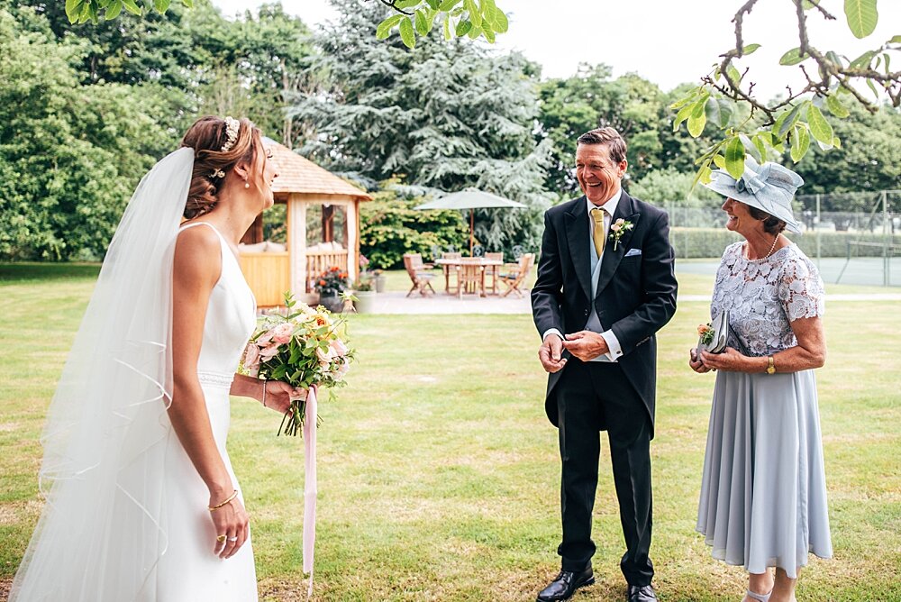 English country garden marquee wedding with Summer Pastels, Smokebombs, Hanging Flower Installation. Food by Gather &amp; Feast . Essex Documentary Wedding Photographer  