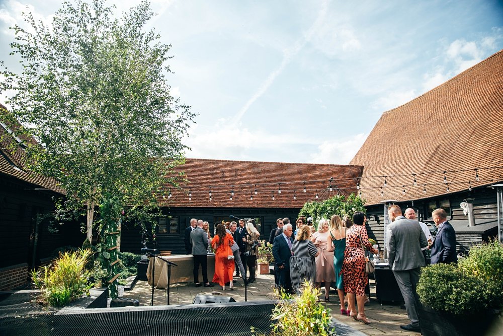 Wild Meadow inspired Sail cloth marquee wedding at Little Tey Barn with romantic hand written banners, cascading bouquets, embellished pastel bridesmaids. Essex documentary wedding photographer