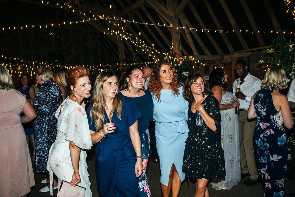 Wild Meadow inspired Sail cloth marquee wedding at Little Tey Barn with romantic hand written banners, cascading bouquets, embellished pastel bridesmaids. Essex documentary wedding photographer