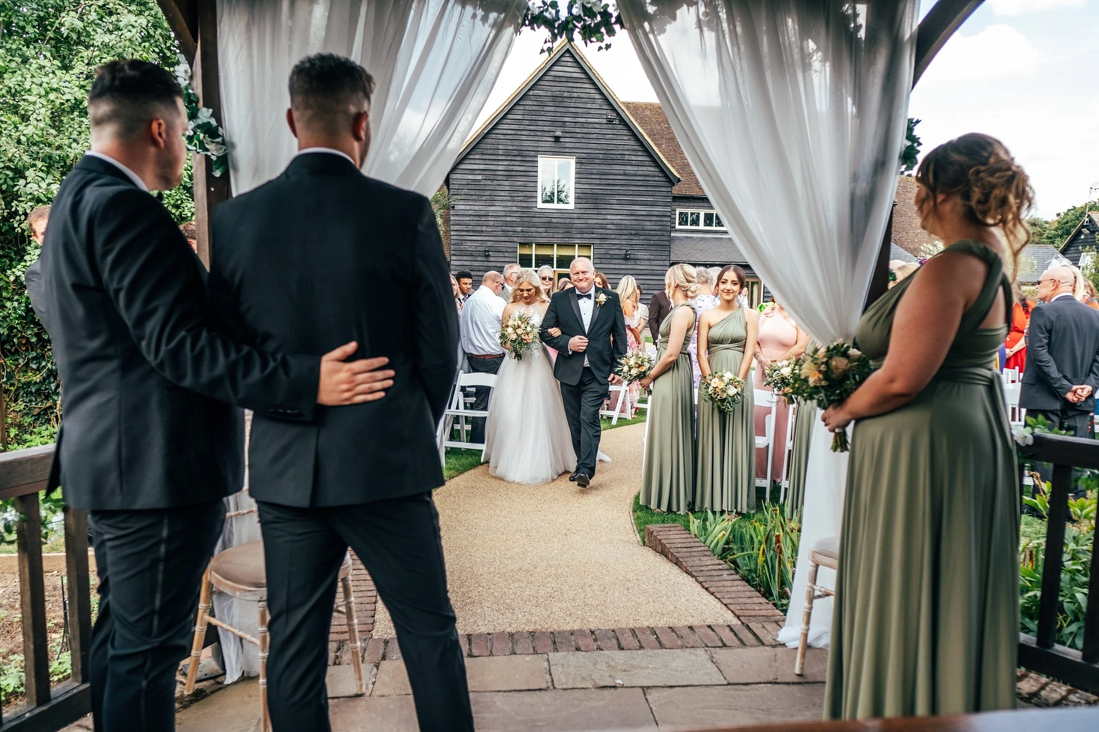 Delicate sage &amp; white paired with black tie for an early Autumn barn wedding at The White Hart, Great Yeldham. Essex documentary wedding photographer